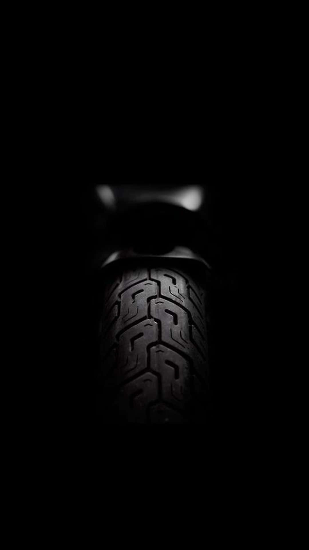 A Close Up Of A Tire In The Dark Wallpaper