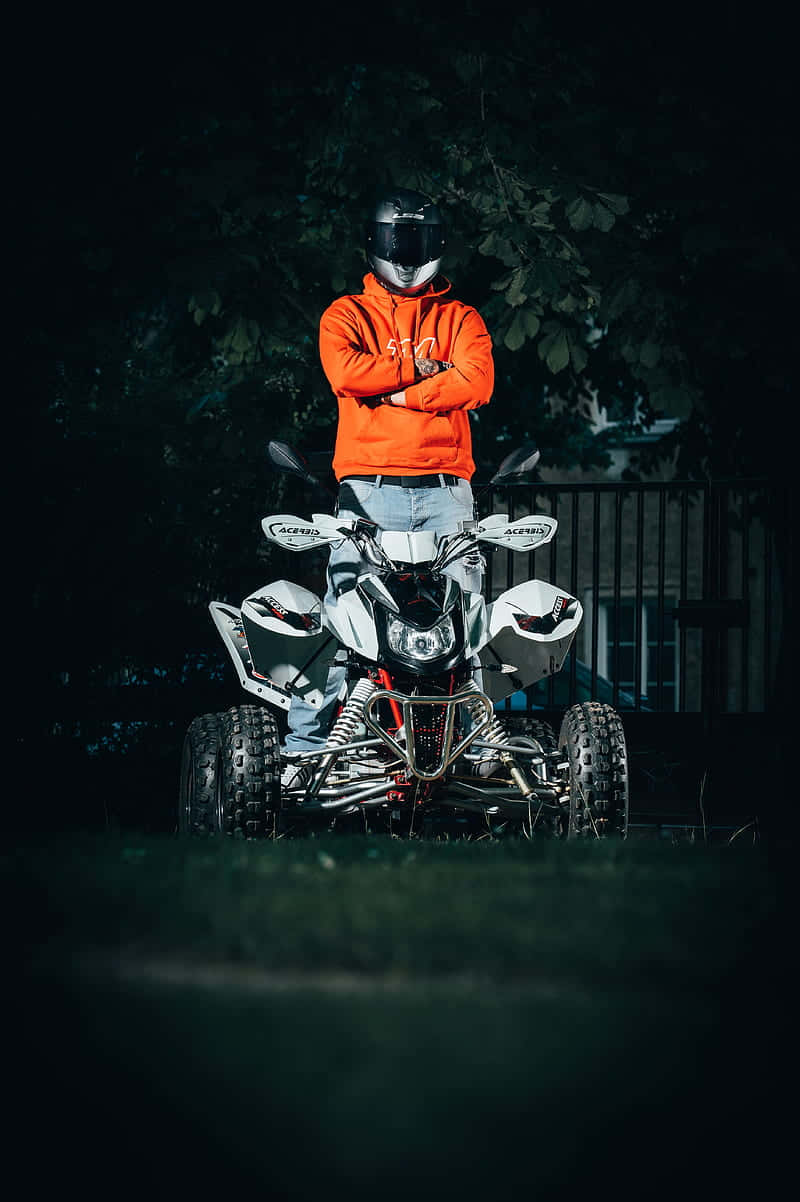Motorcyclist Standing Behind A T V Wallpaper