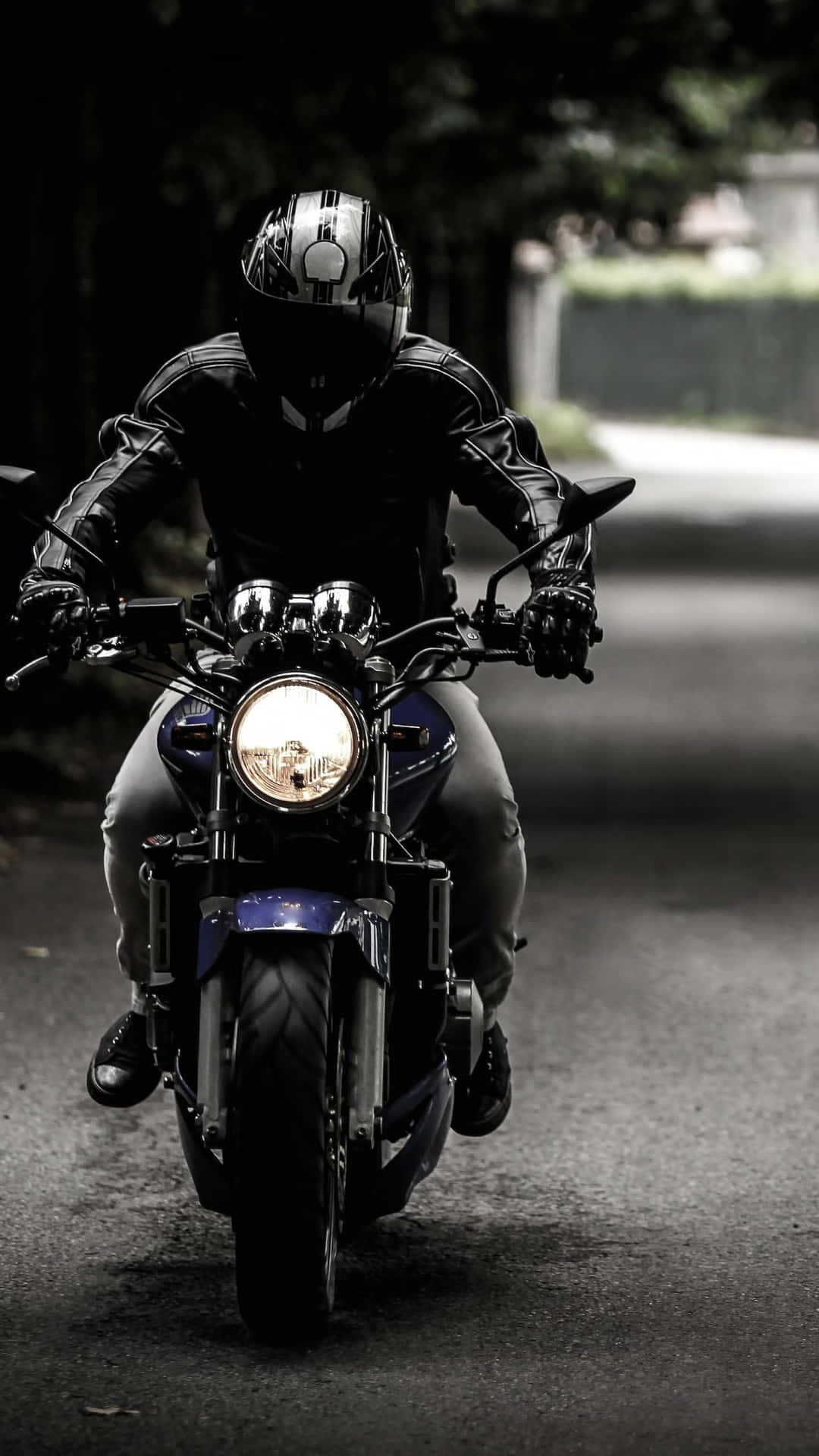 Motorcyclistin Actionon Road Wallpaper