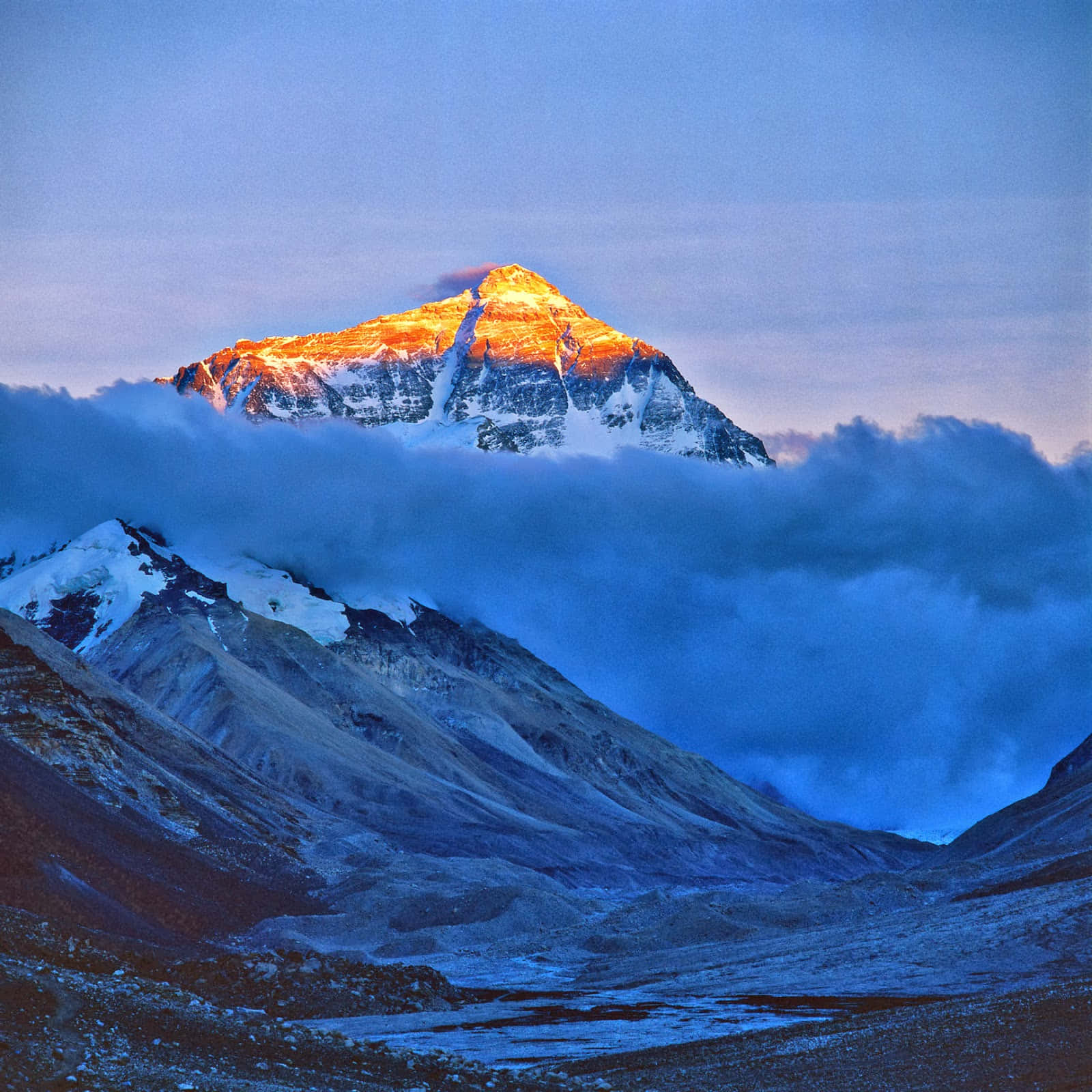 Standing tall and majestic, Mount Everest soars above the clouds
