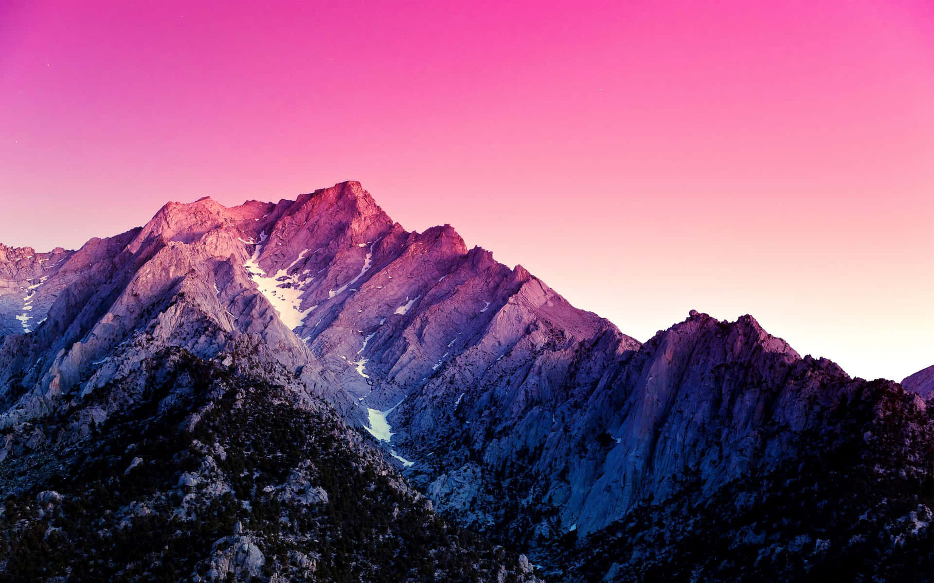 A breathtaking view of snow-capped mountains at sunrise