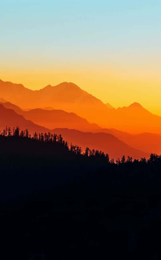 A magical sunset behind mountains Wallpaper