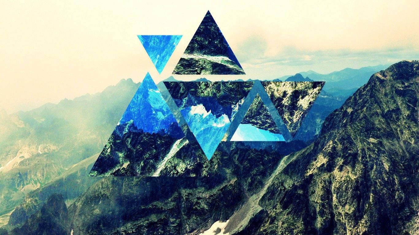Geometric polyscape featuring three sharp-edged stone triangles off a snow-capped mountain. Wallpaper