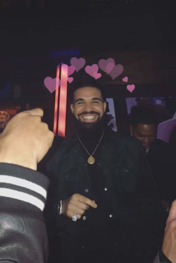 "#MoveWithIt" Wallpaper — Drake smiles brightly in a dimly lit club with pink heart graphics floating above his head.