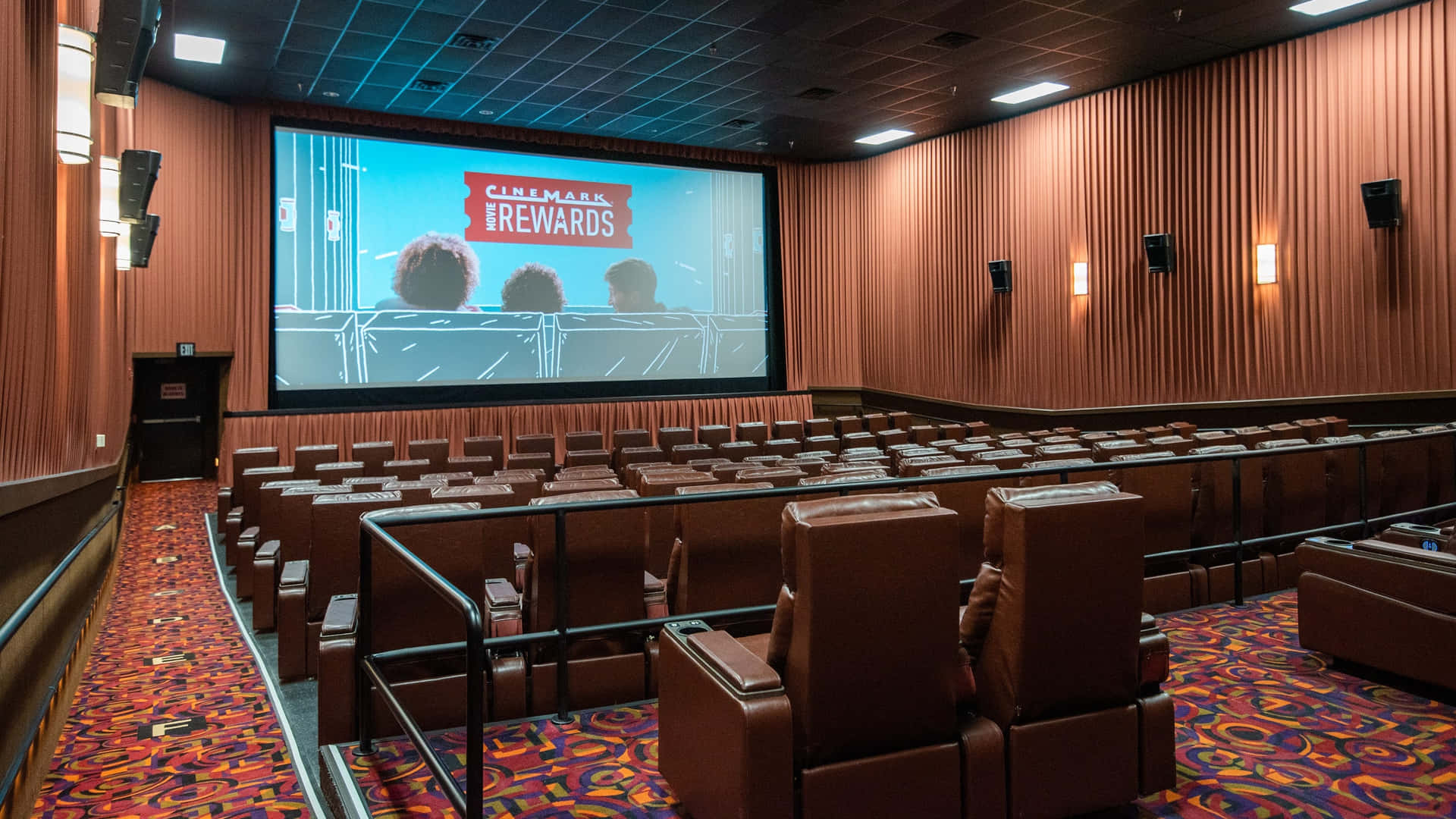 A Theater With A Screen And Chairs Wallpaper