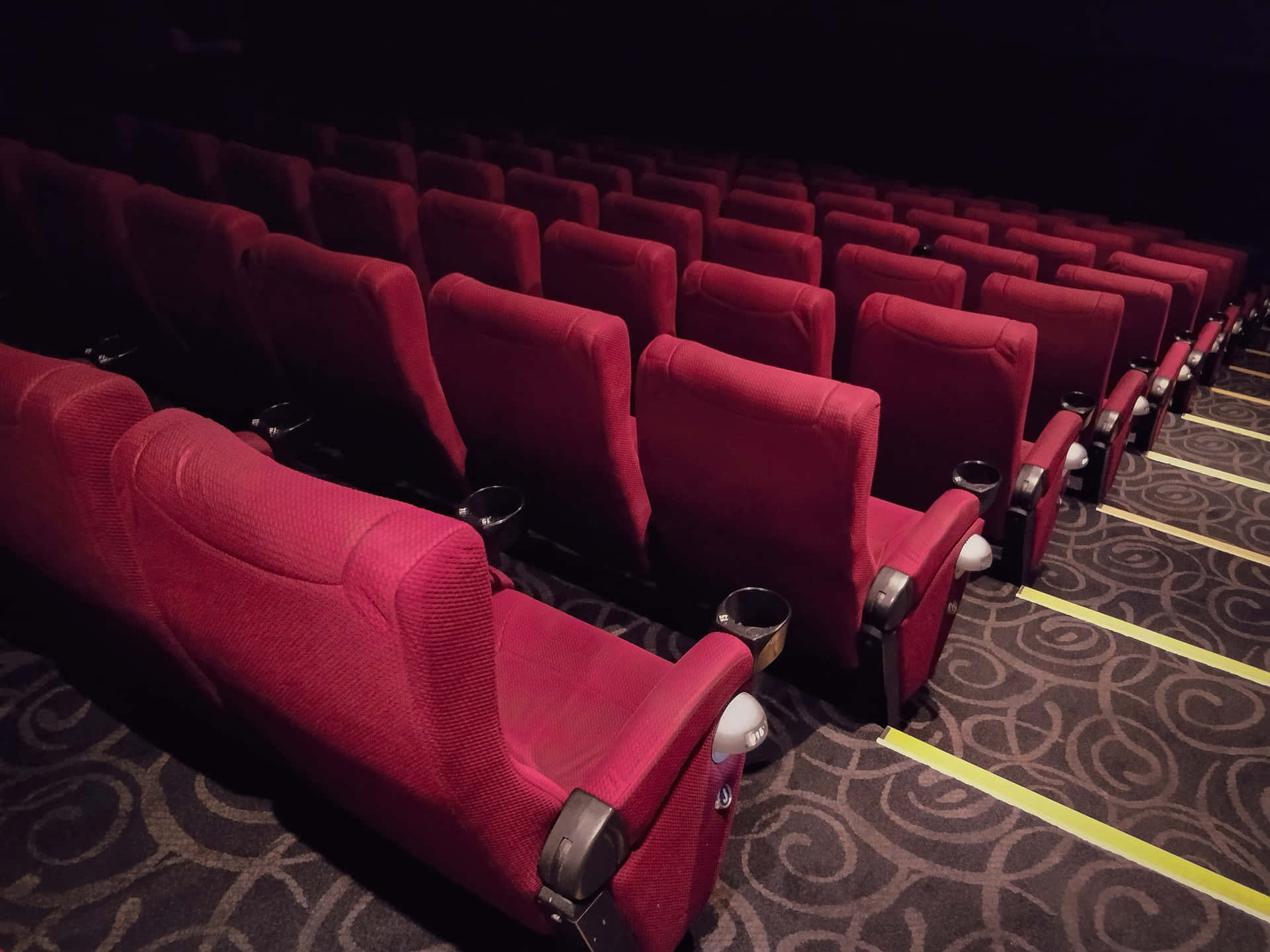 Movie Theater Red Chairs And Clean Brown Carpet Wallpaper
