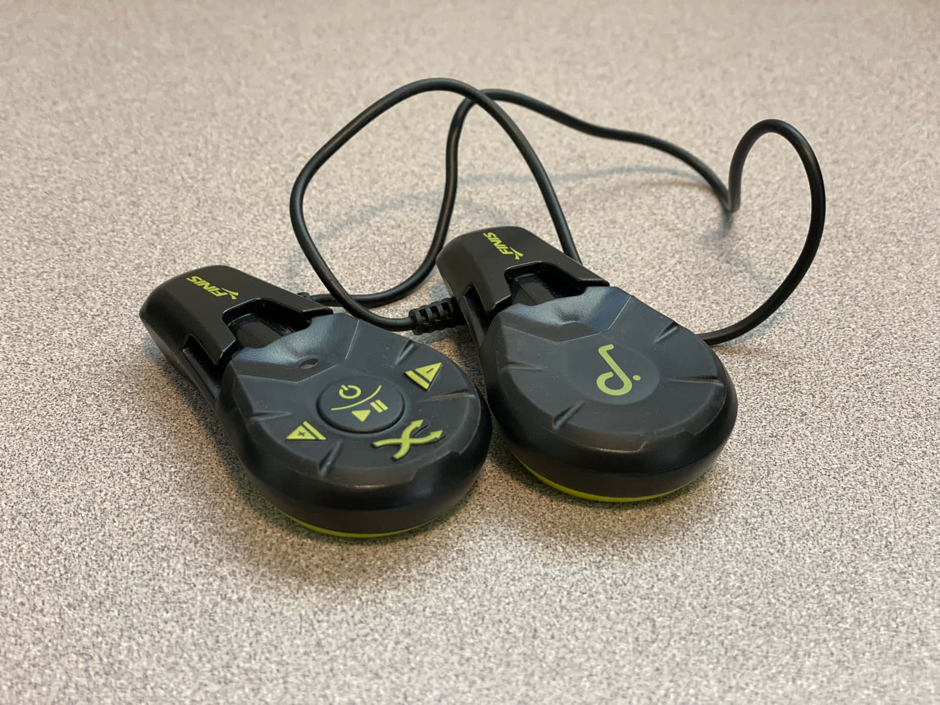 two wireless headphones with a yellow cord