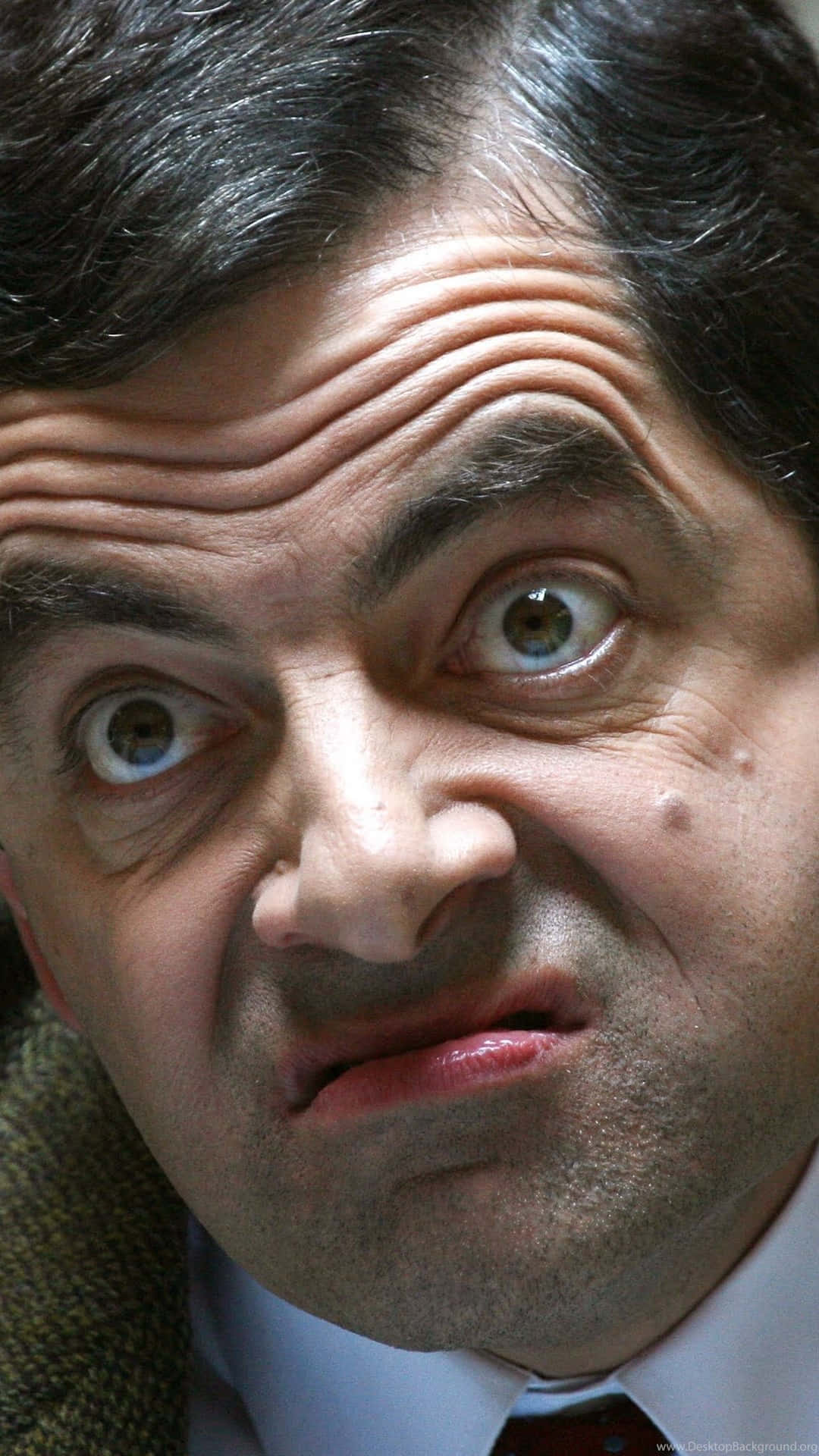 Mr. Bean in his Mini Cooper making a funny face
