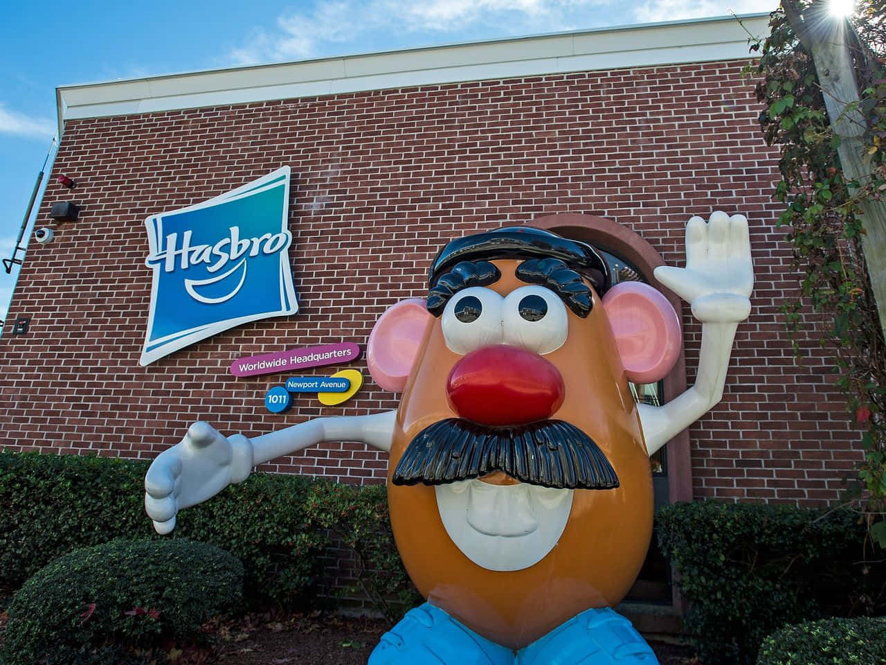A Statue Of A Potato With A Mustache In Front Of A Building