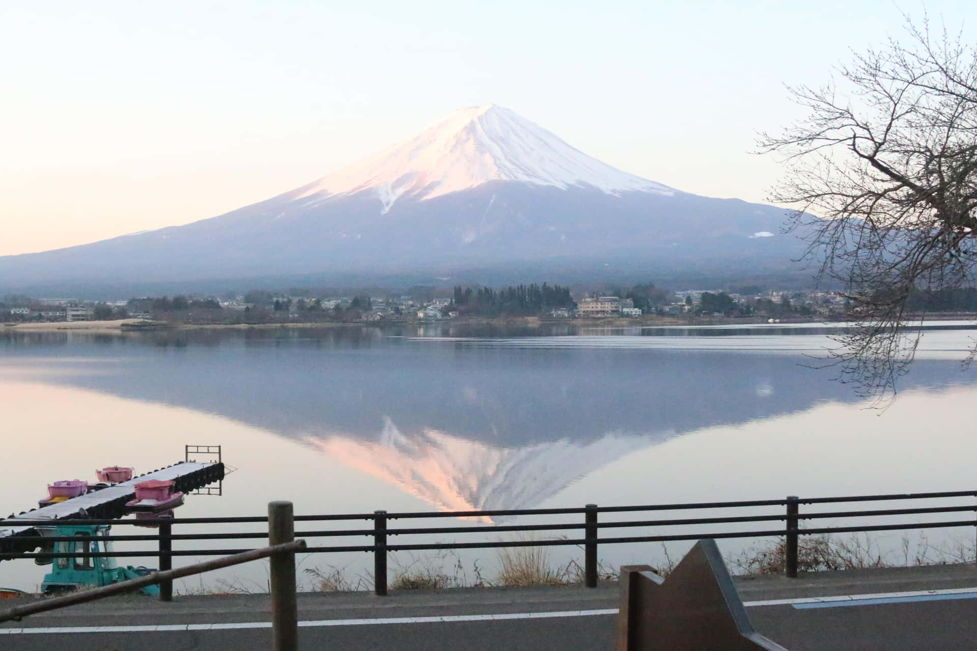 The majestic Mt Fuji stands tall above a navy blue sea.