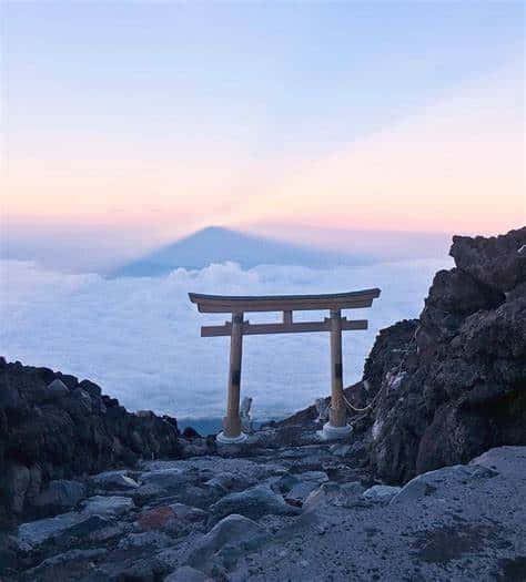 A Torii Gate On Top Of A Mountain