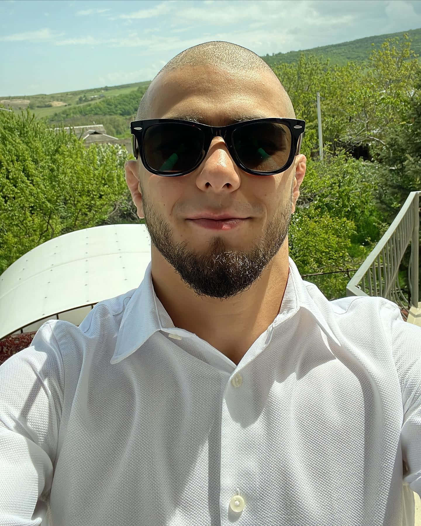 Muhammad Mokaev Relaxing And Wearing Shades Wallpaper