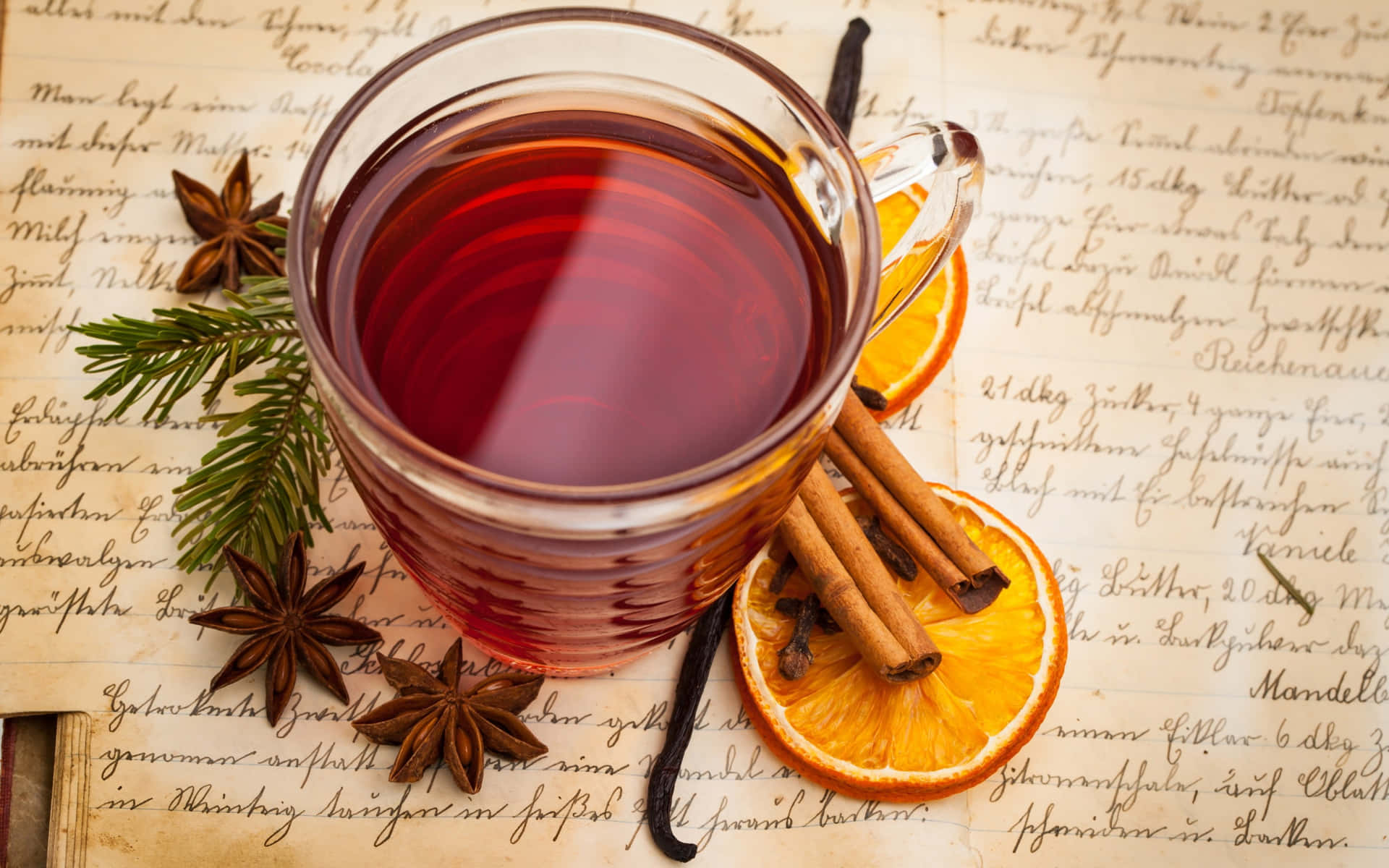 Delicious Warm Mulled Wine in a Glass with Spices Wallpaper
