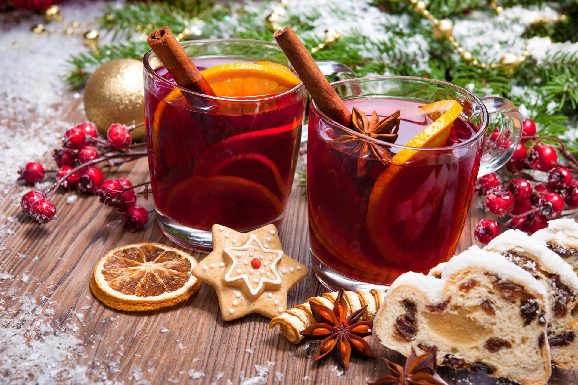 A steaming cup of mulled wine garnished with a cinnamon stick and orange slice Wallpaper
