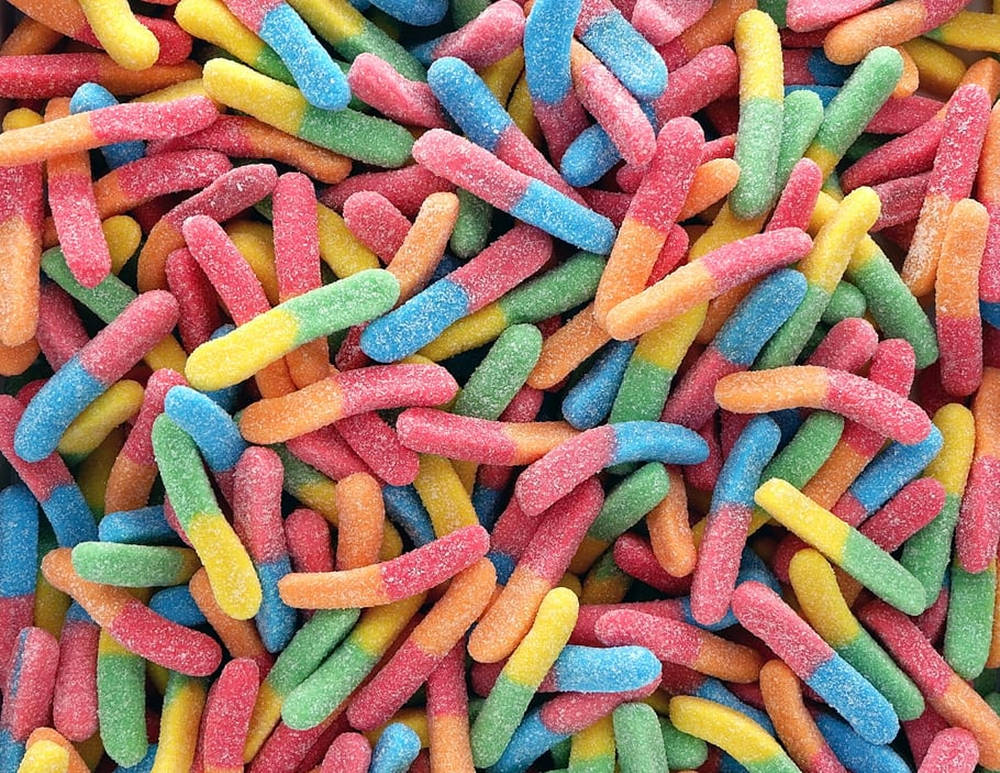 A colorful collection of sour worm sugar candies Wallpaper