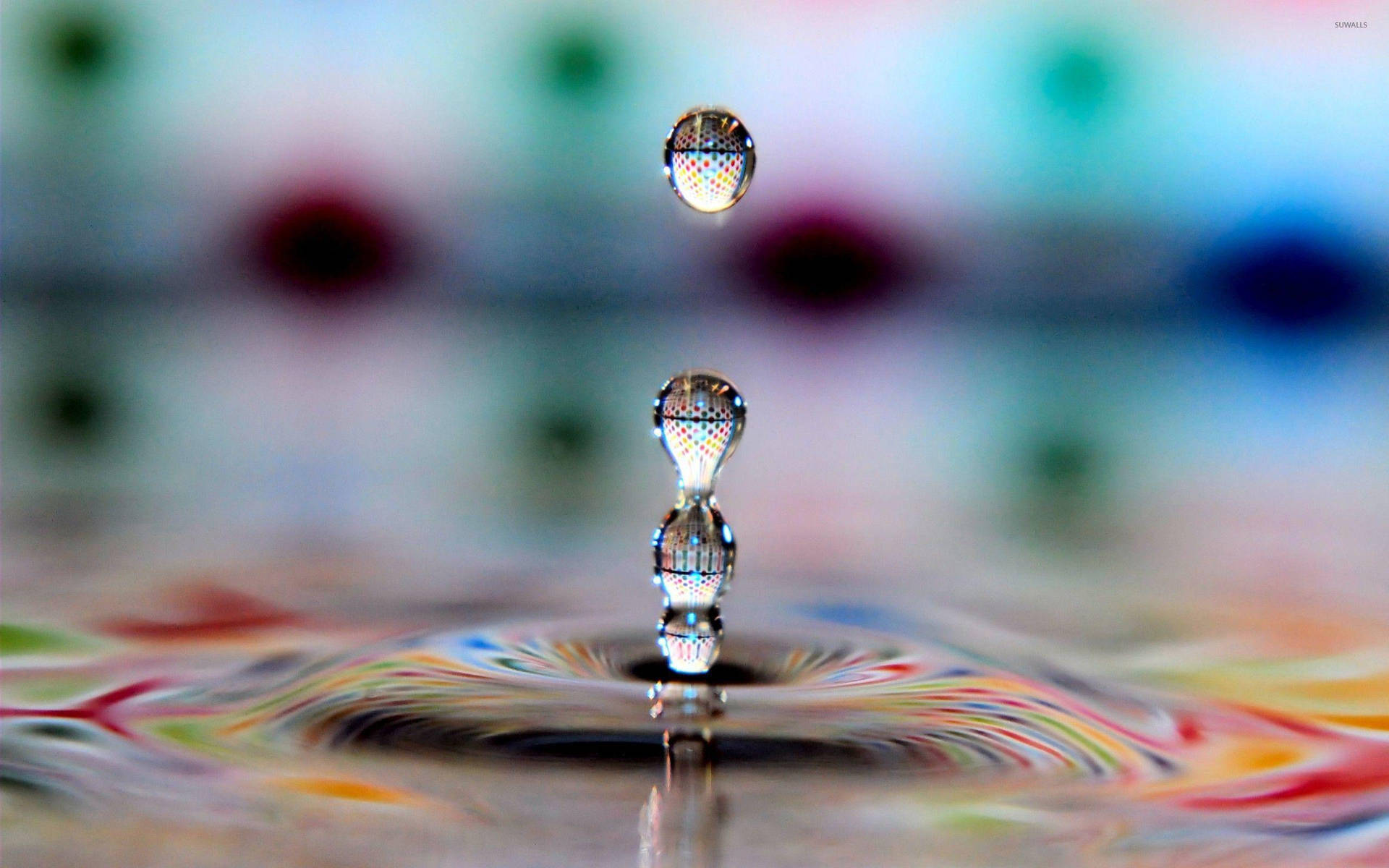 Multiple Droplets On Rippling Water Wallpaper