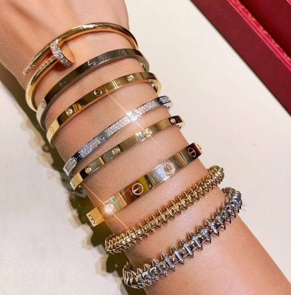 Multiple Two-toned Cartier Bracelets Wallpaper