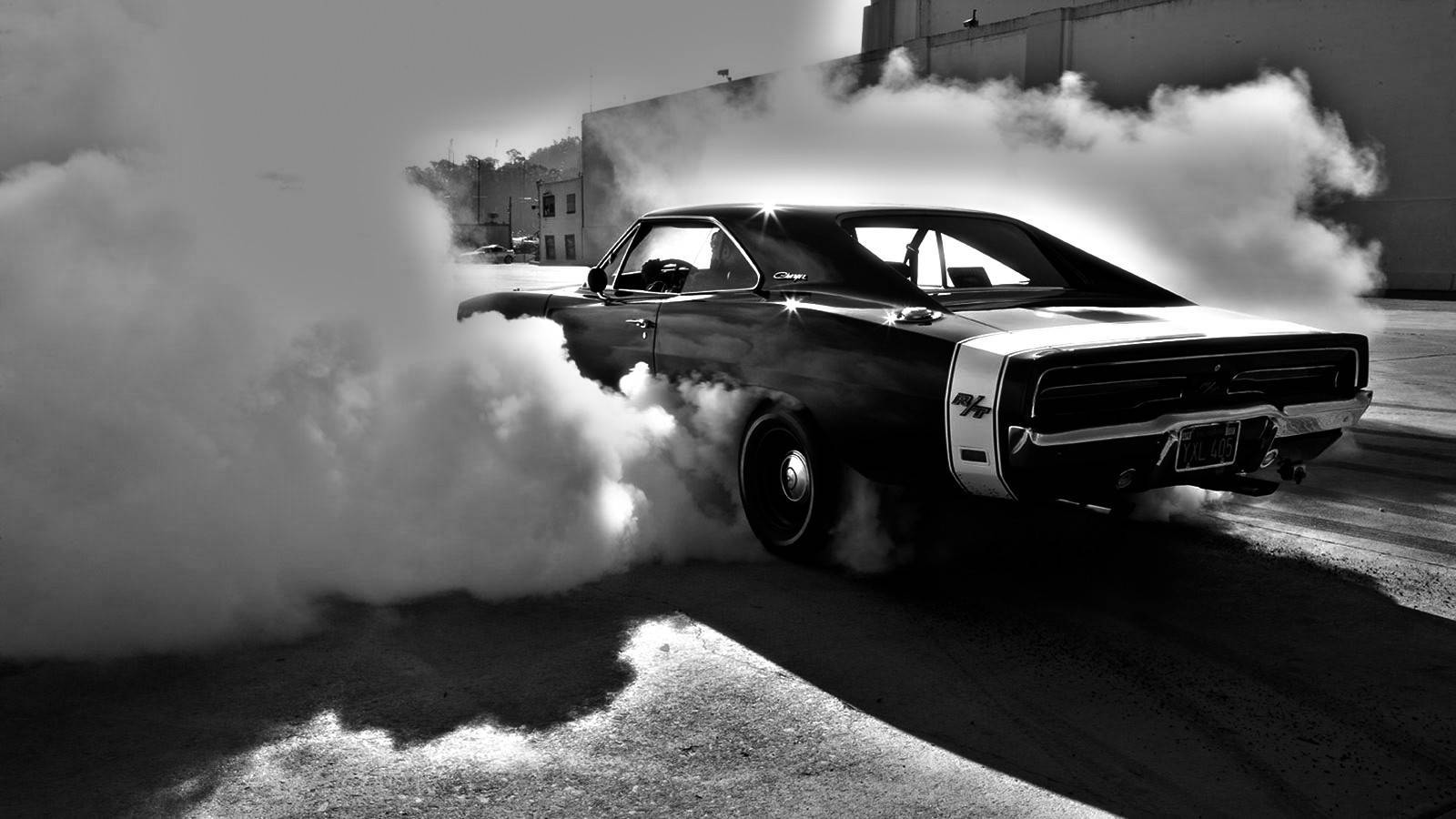 Roaring Muscle Car Enveloped in Smoke Wallpaper