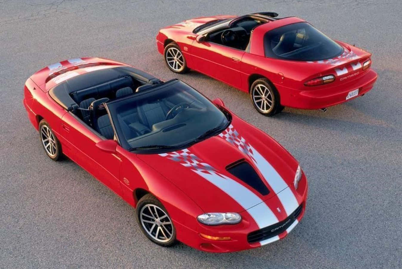 Two Red Sports Cars Are Shown Side By Side