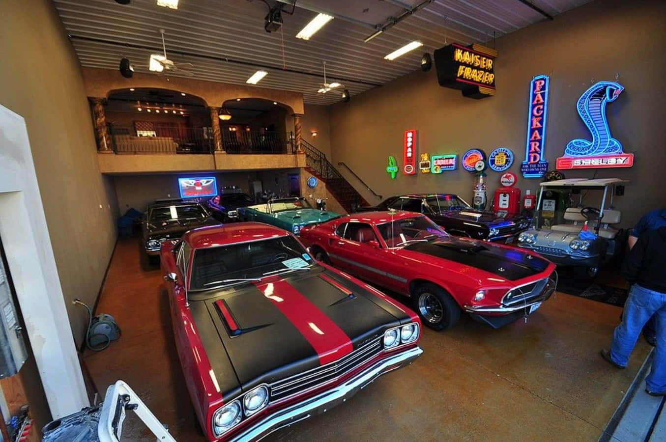 A Garage With Several Classic Cars In It