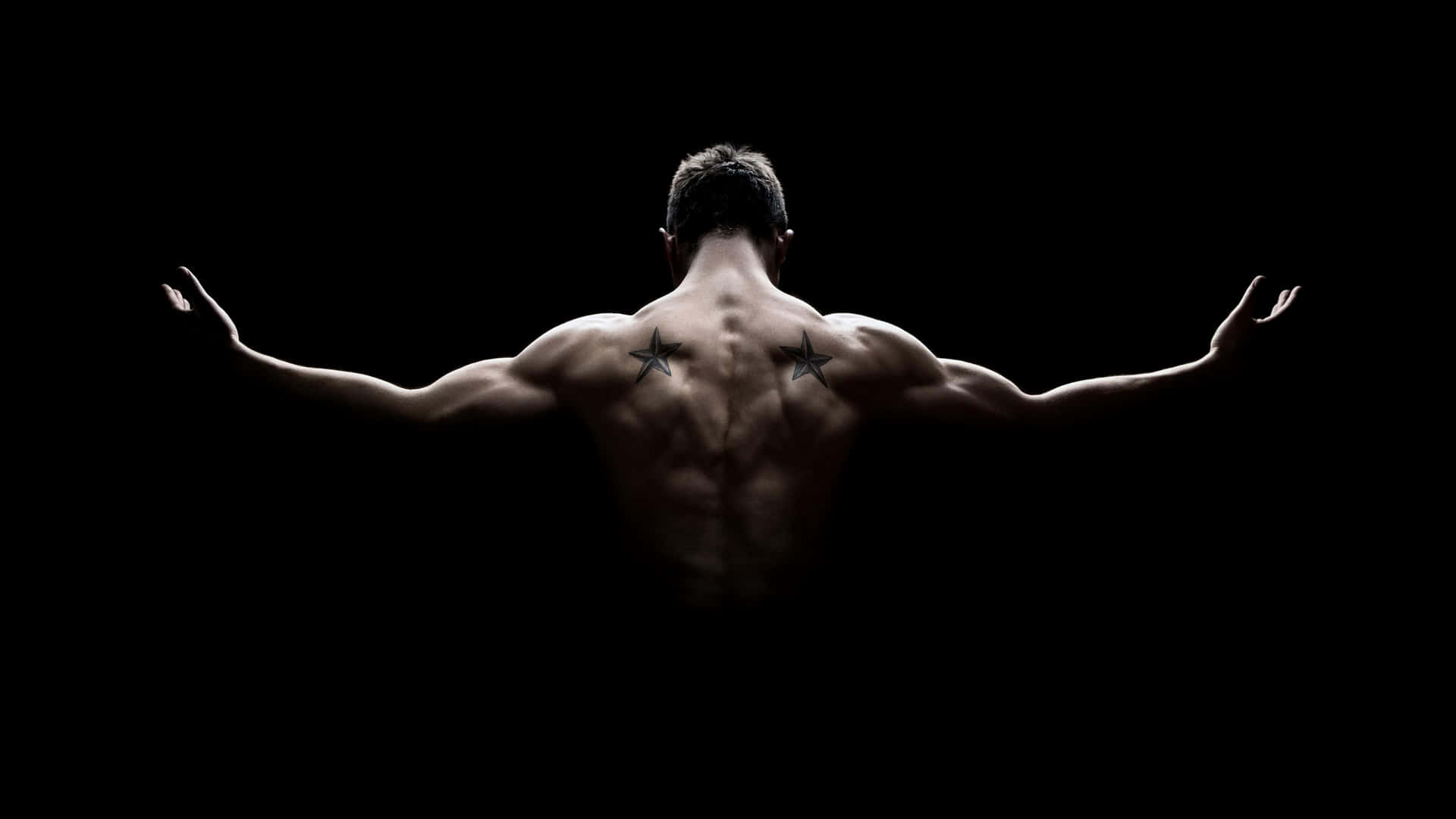 Muscular Back Posein Darkness Wallpaper