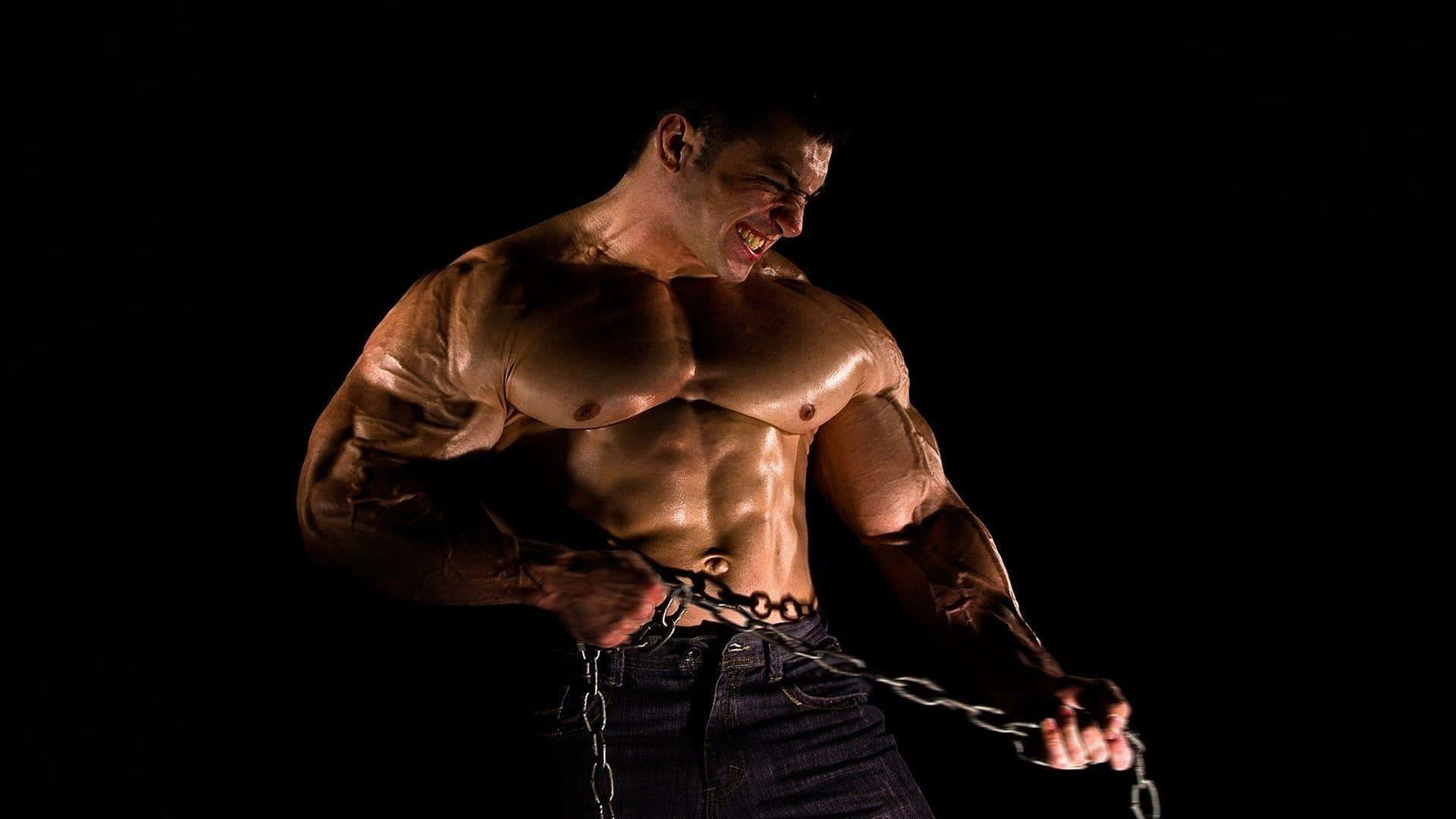 Muscular Man Breaking Chains Wallpaper