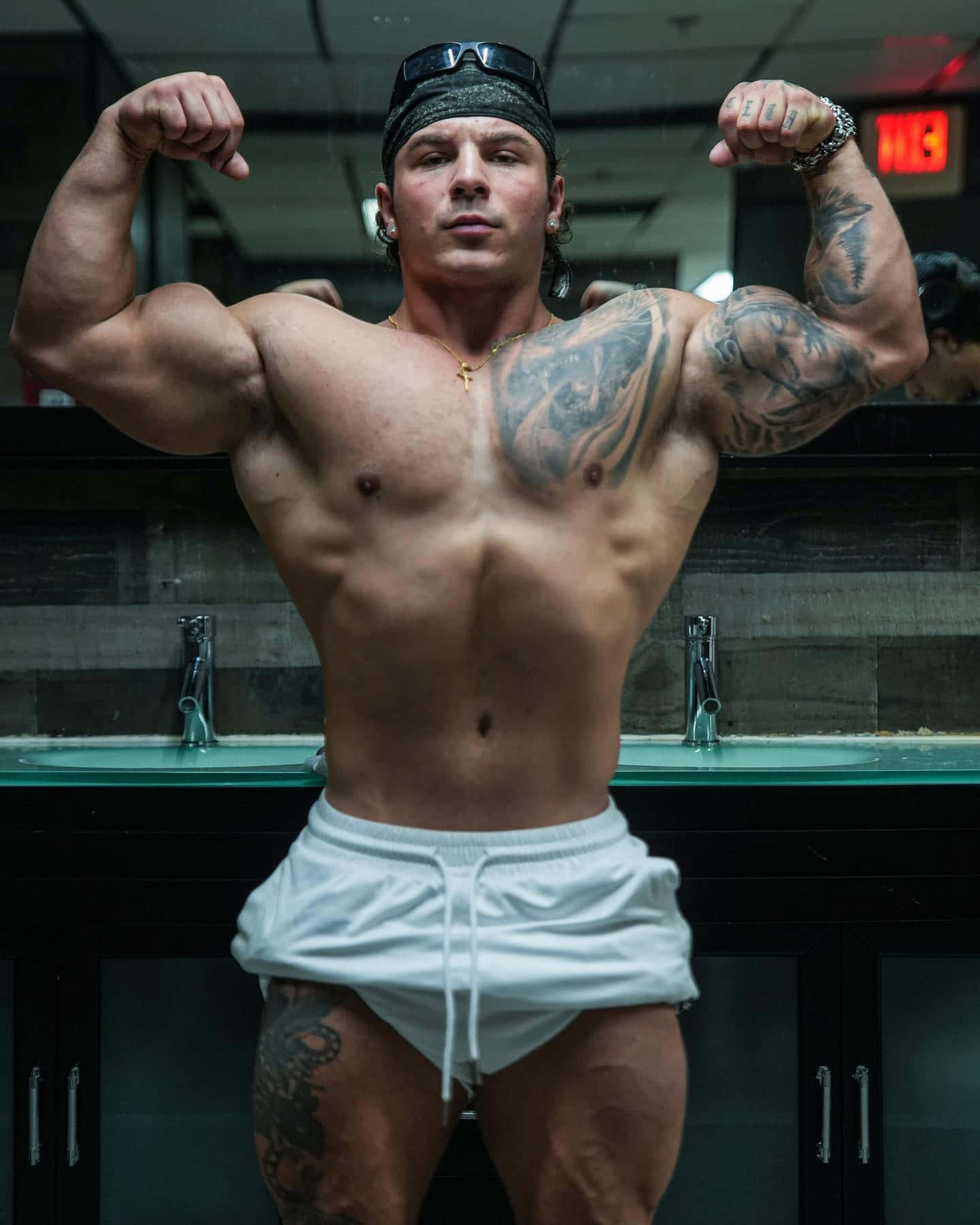 Muscular Man Flexingin Gym Locker Room.jpg Wallpaper