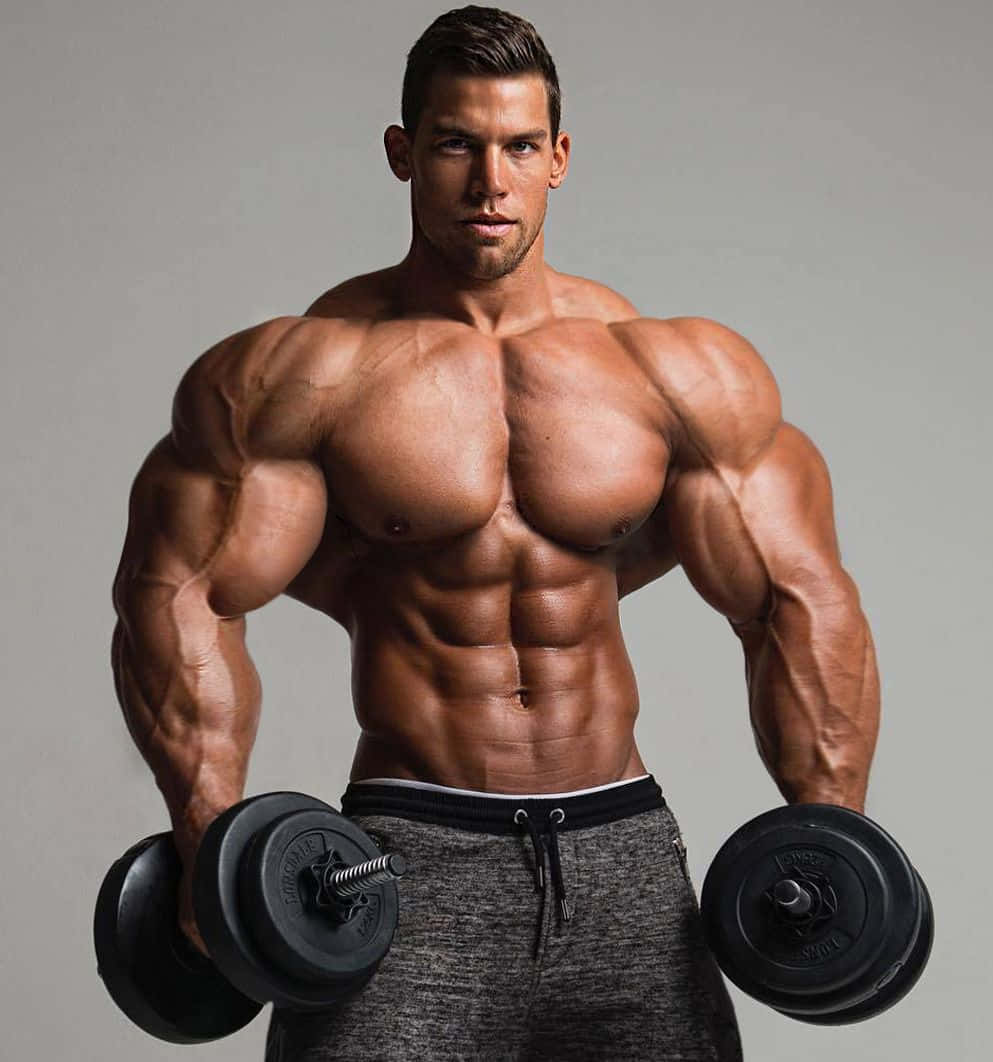 Muscular Man Holding Dumbbells Wallpaper