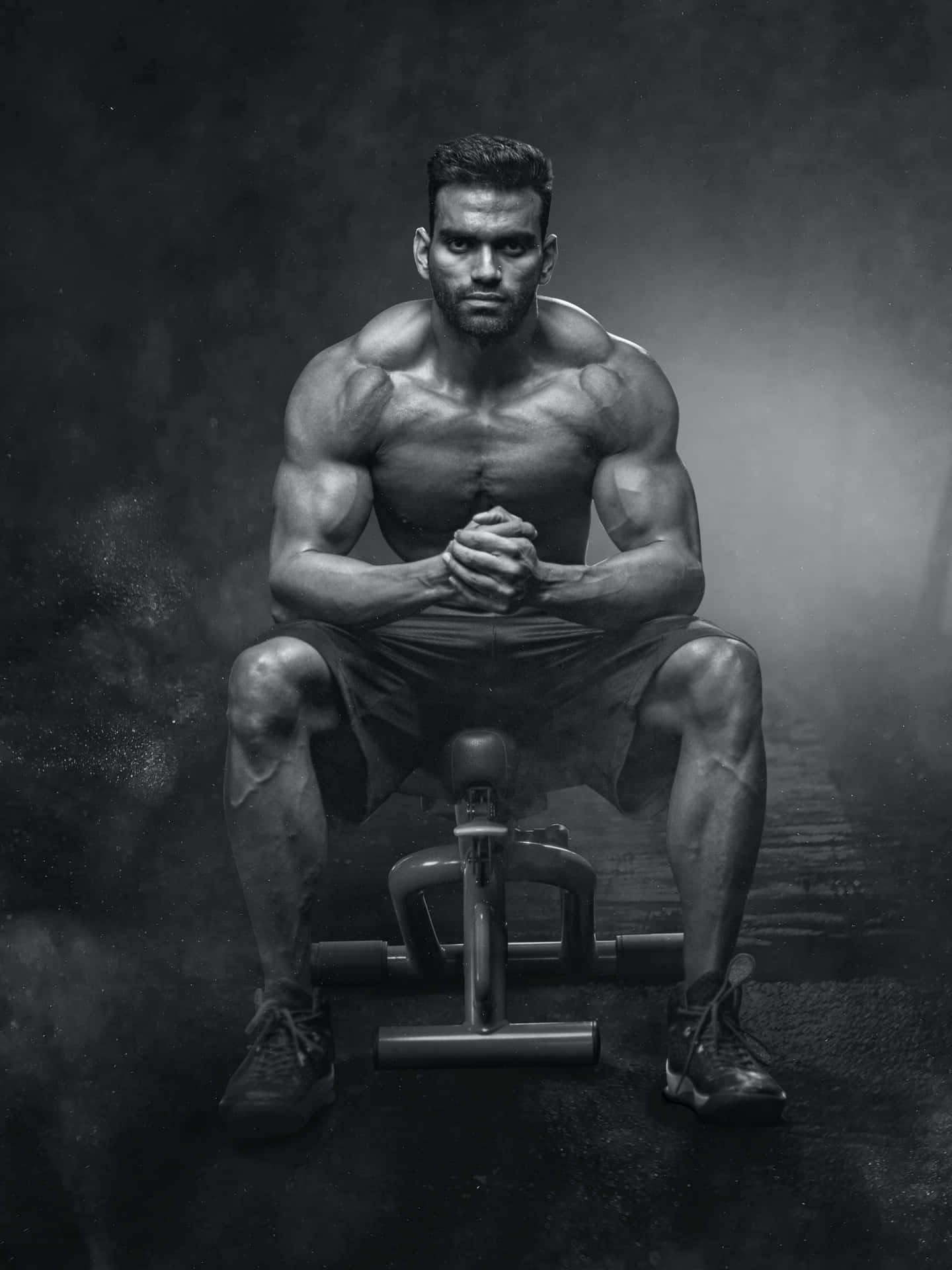 Muscular Man Intense Gym Workout Wallpaper