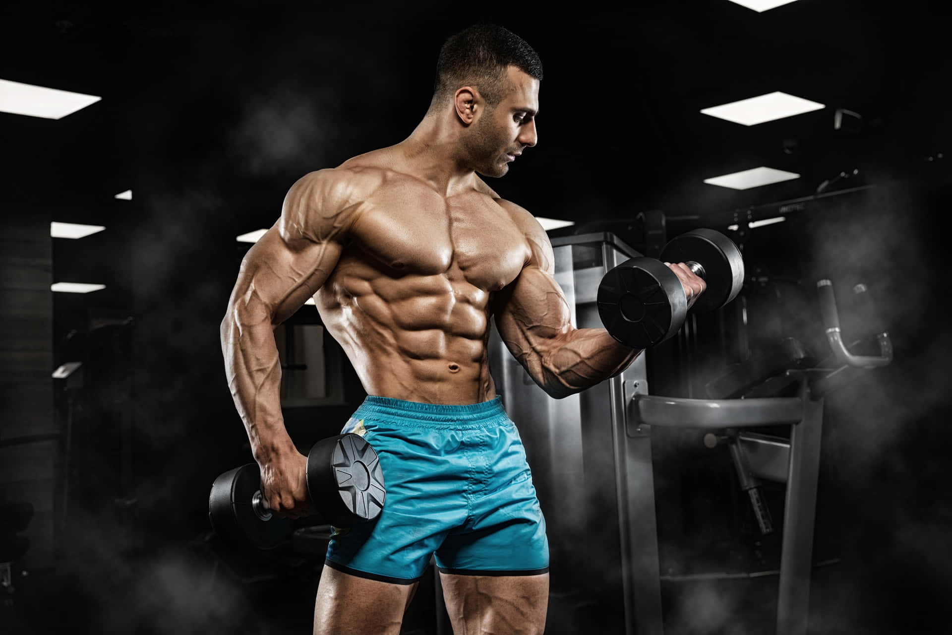 Muscular Man Performing Bicep Curls Wallpaper