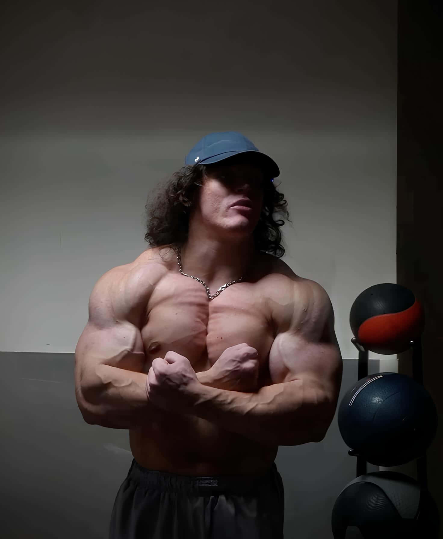 Muscular Man Posingin Gym Cap Wallpaper