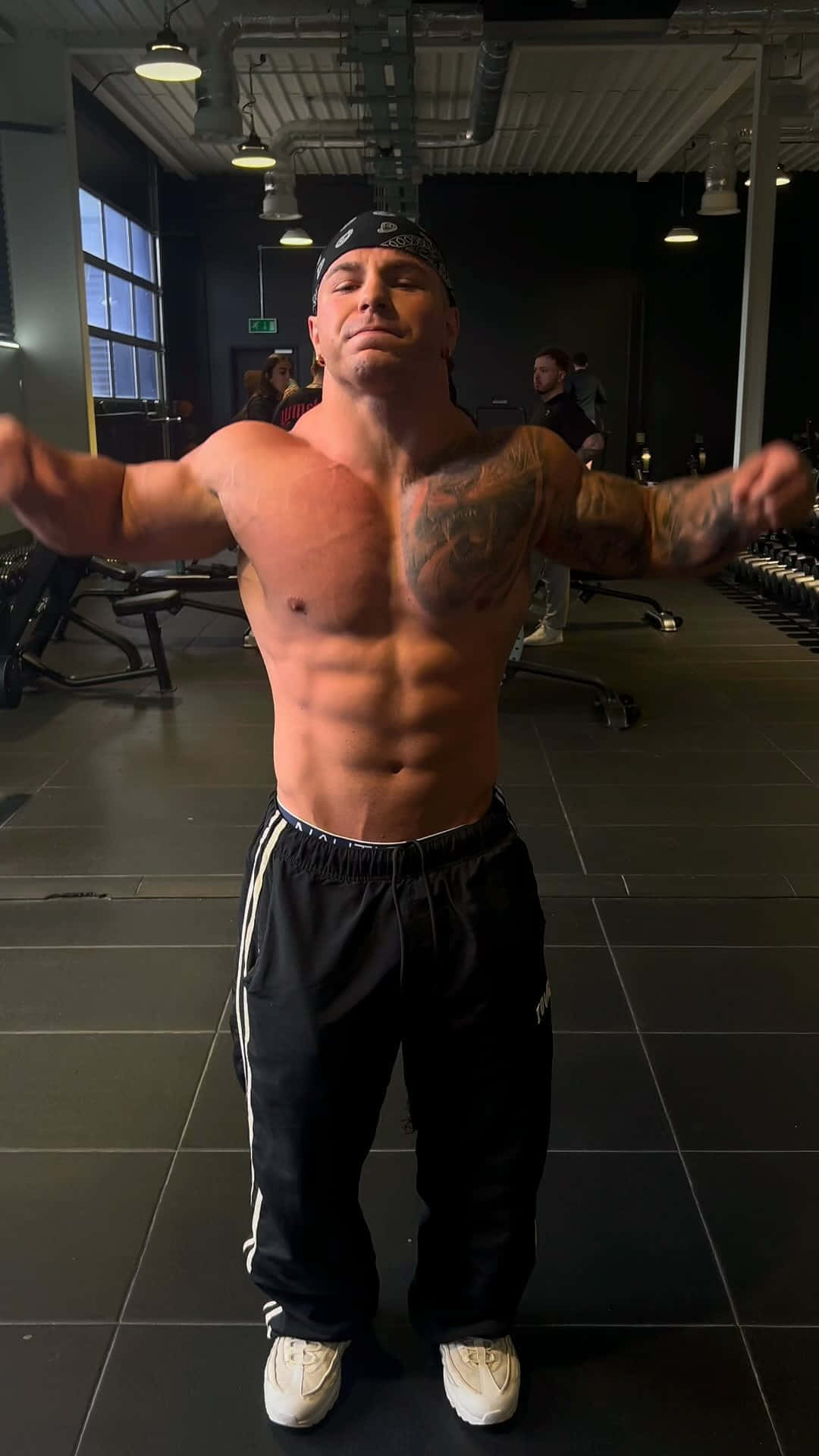 Muscular Man Posingin Gym Wallpaper