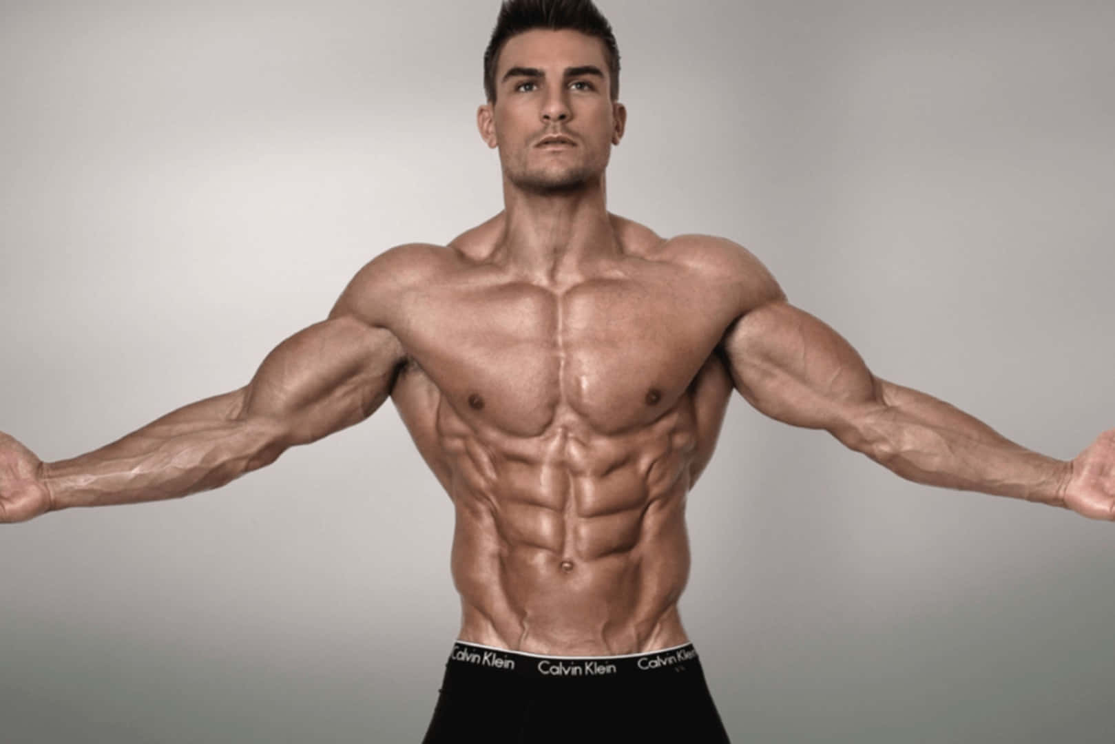 Muscular Man Showing Physique Wallpaper