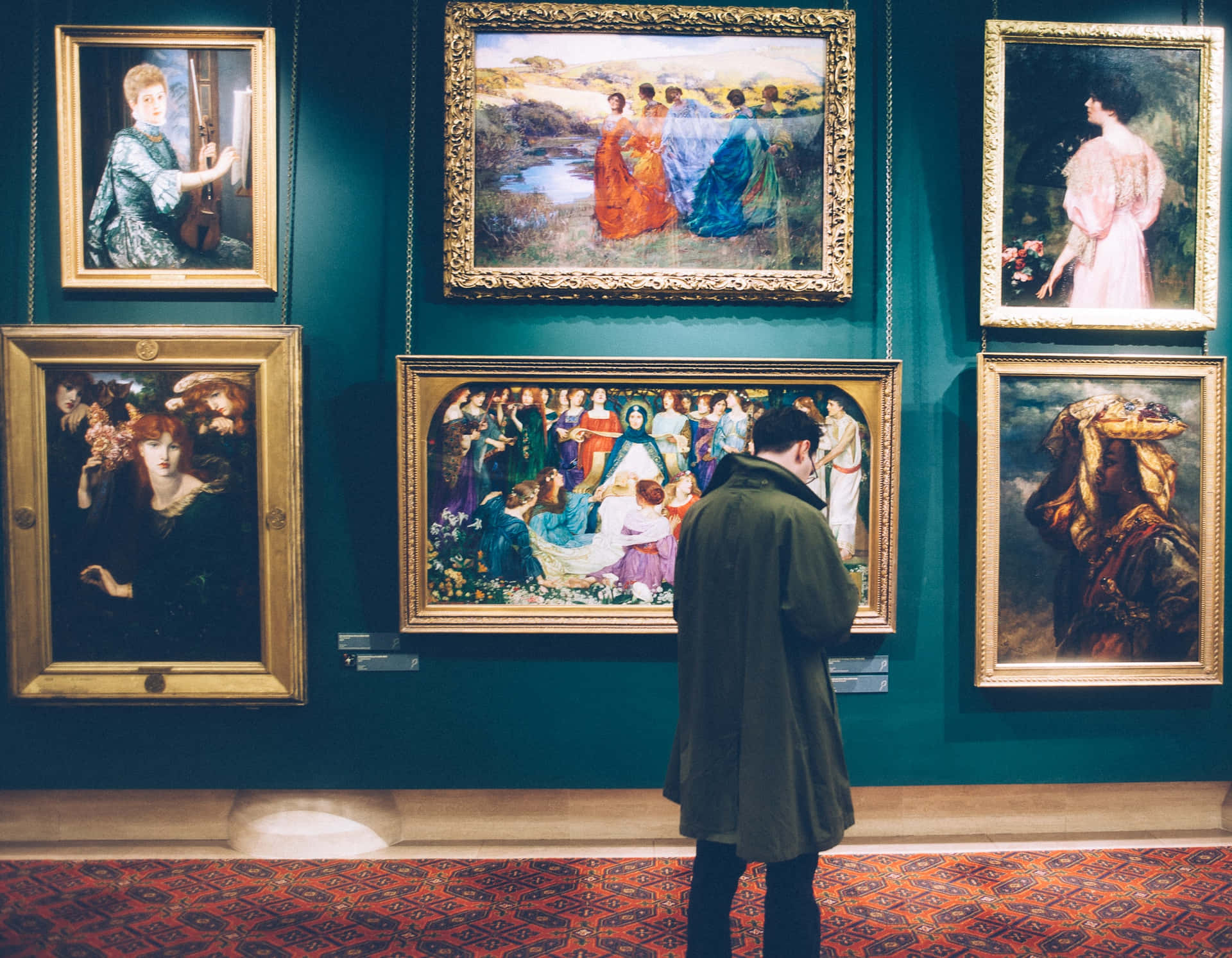 A Man Looking At Paintings In A Museum