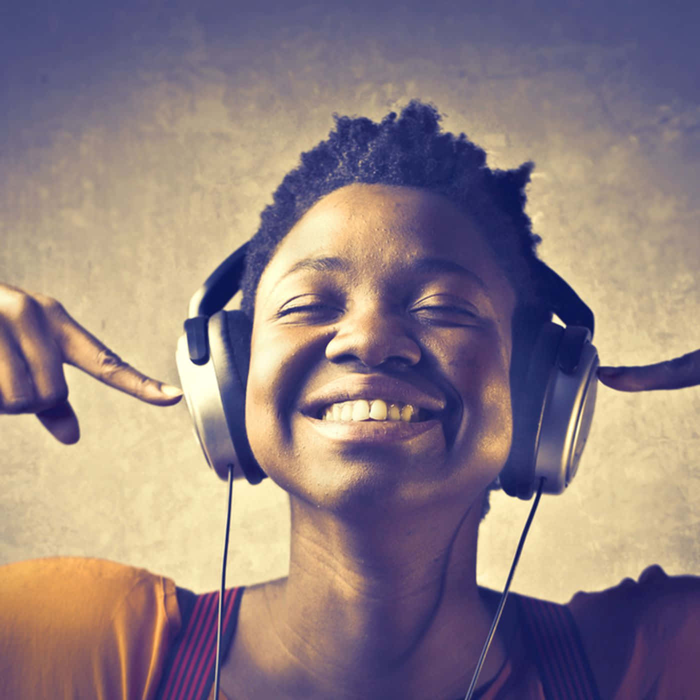 A Woman Wearing Headphones Is Pointing Her Fingers