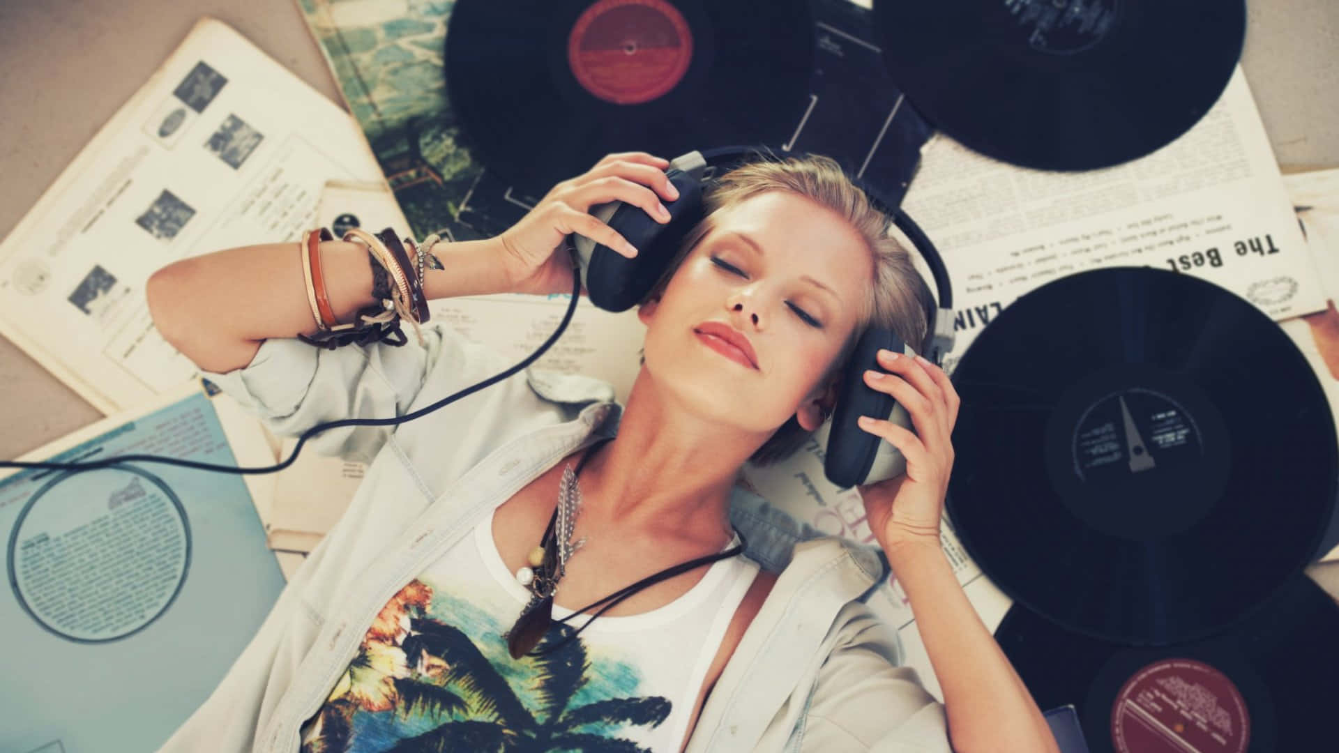 A Woman Listening To Music On Headphones Wallpaper