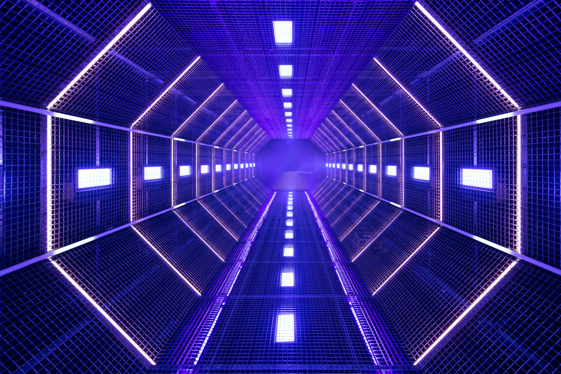 A Futuristic Tunnel With Blue Lights And A Purple Line Wallpaper