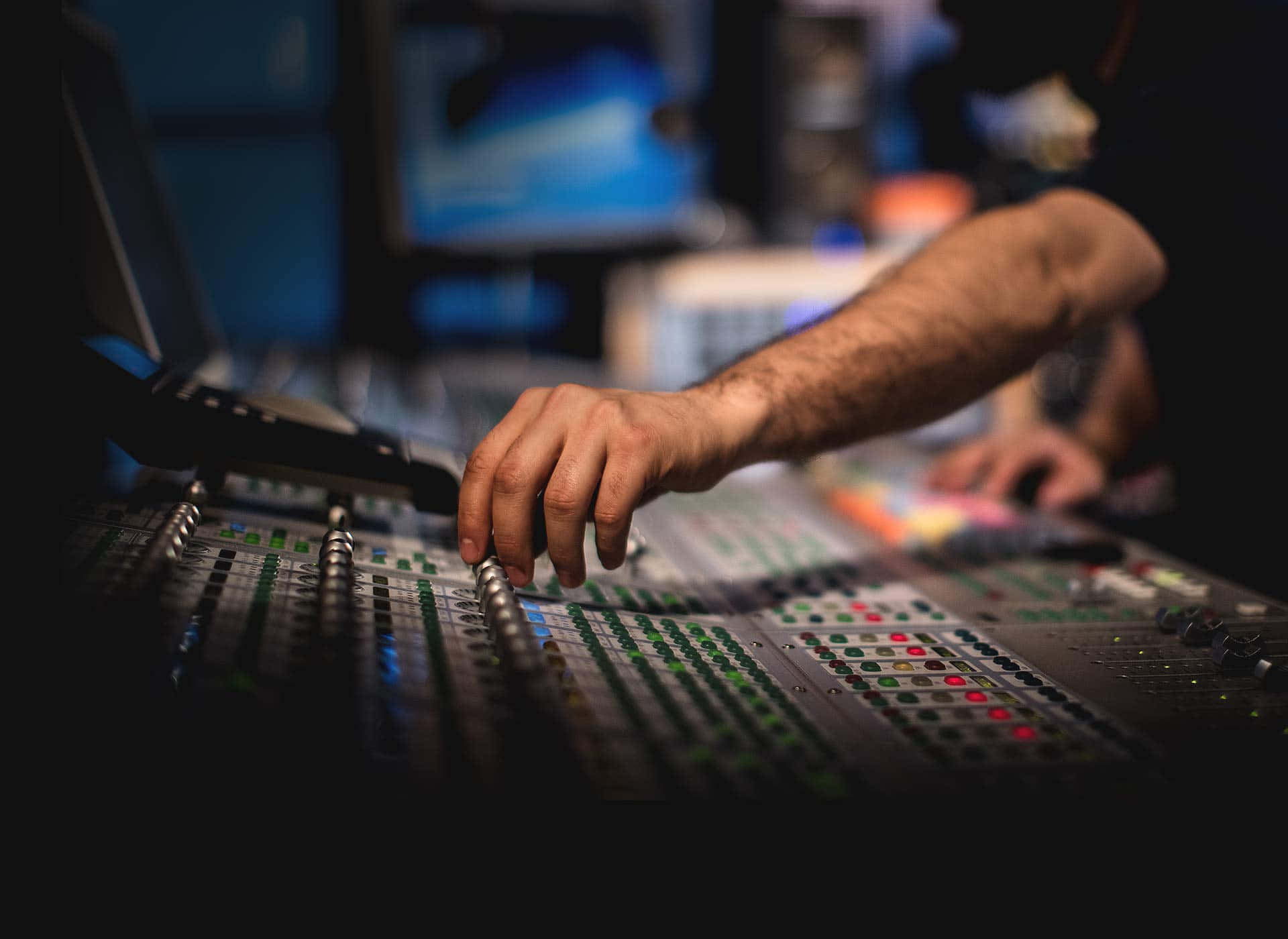 A Man Is Mixing Music In A Recording Studio Wallpaper