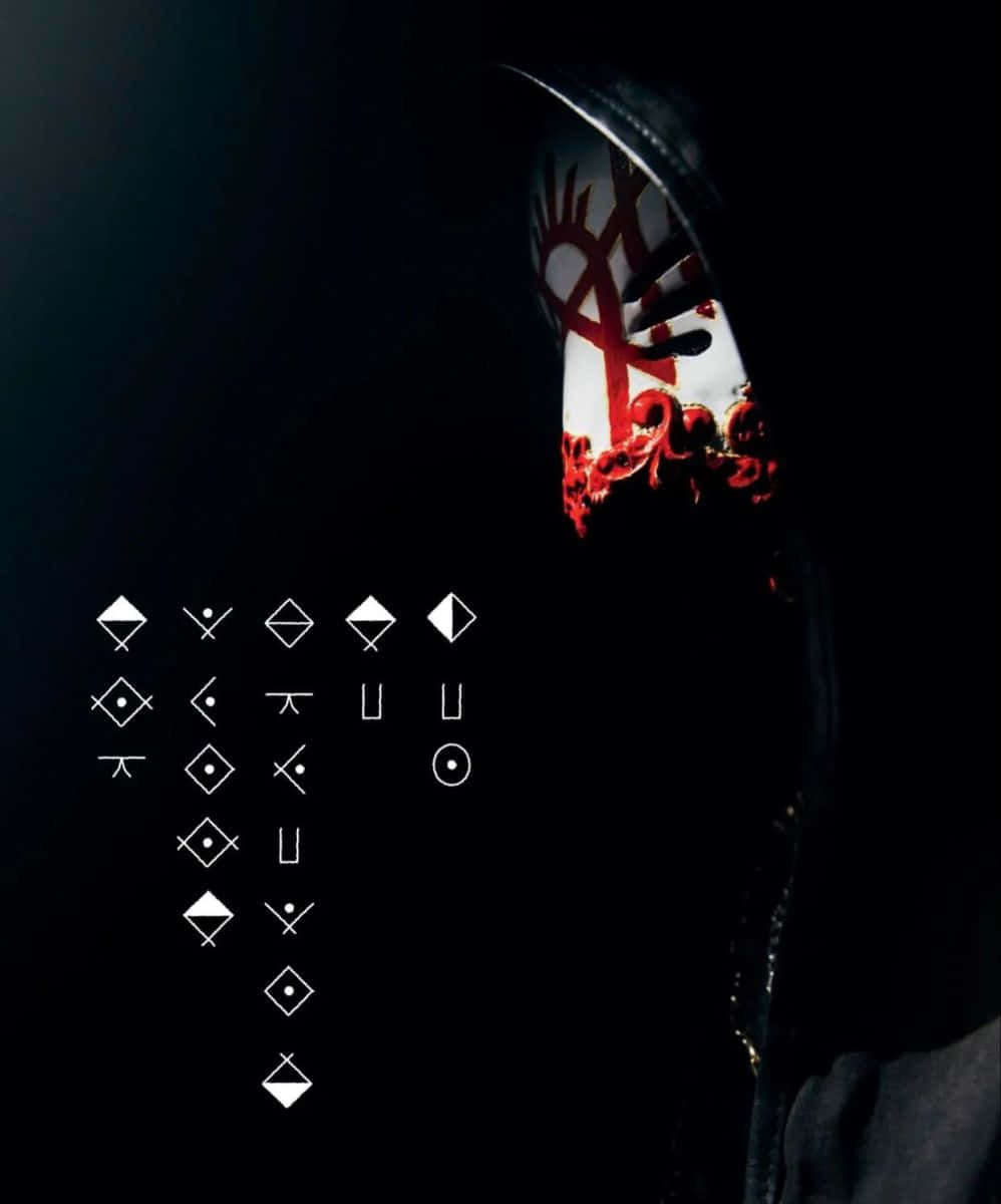 Mysterious_ Figure_with_ Symbolic_ Mask_and_ Icons Wallpaper