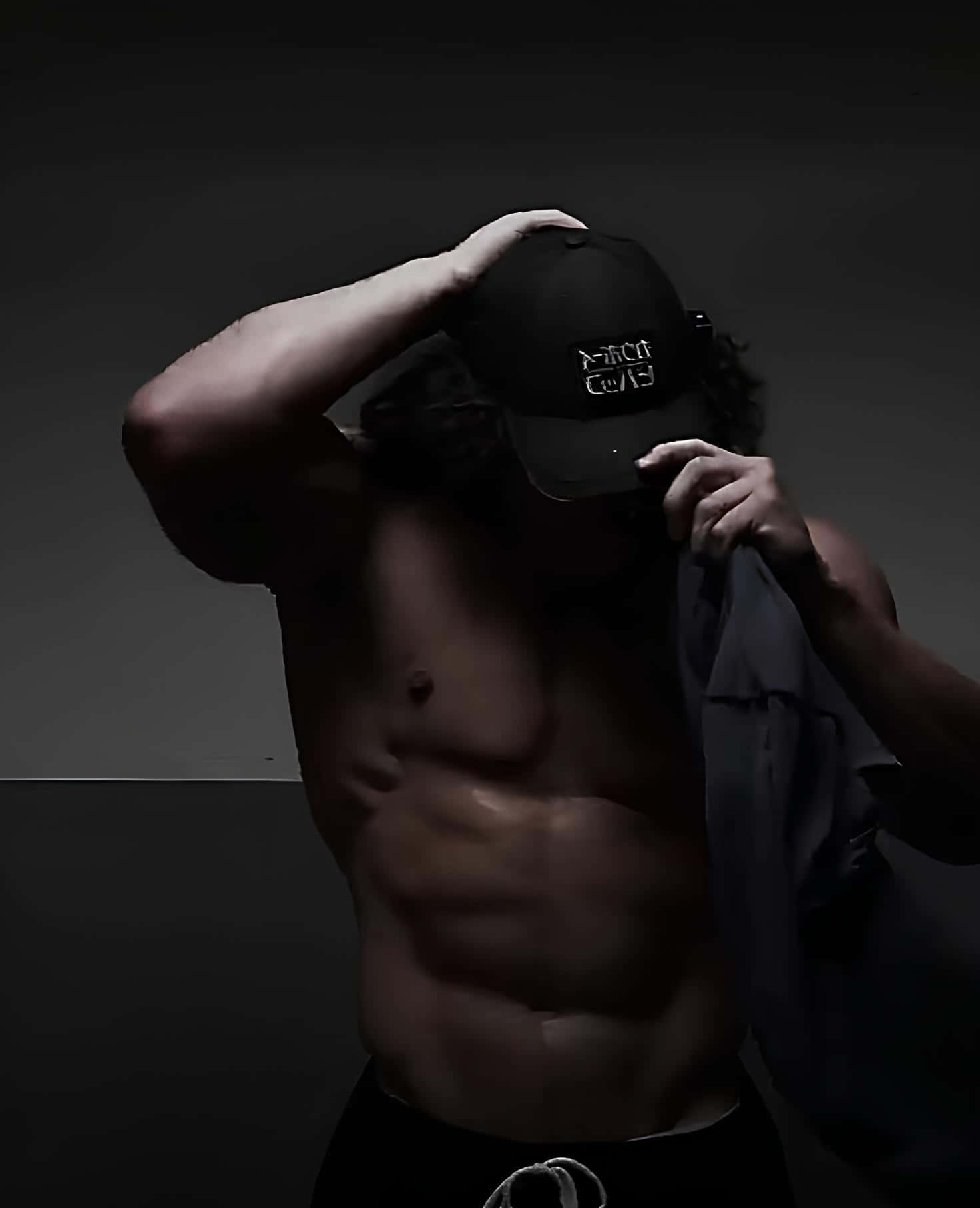 Mysterious Fitness Modelwith Cap Wallpaper