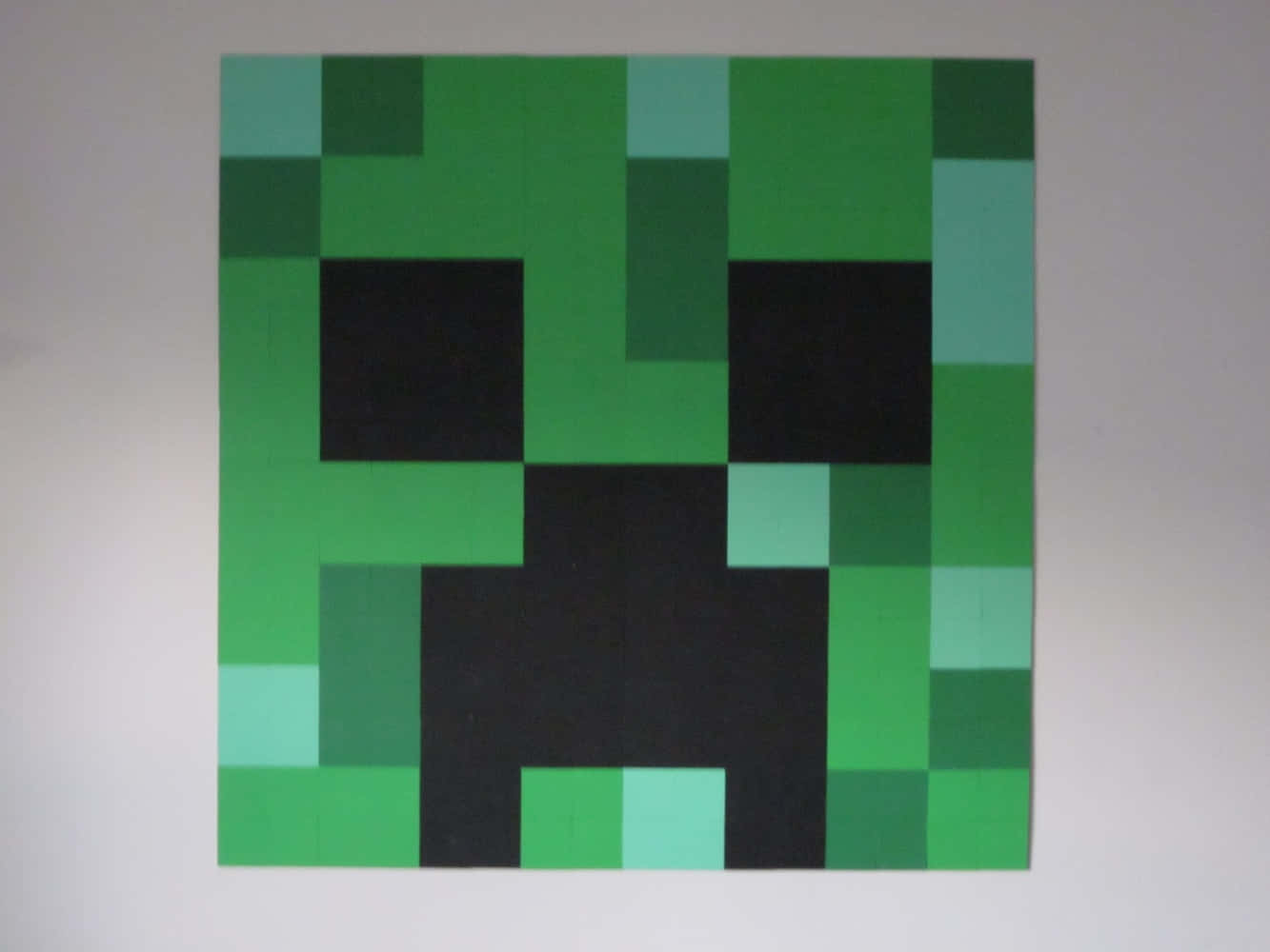 Mysterious Green Creeper Face Amidst Darkness Wallpaper