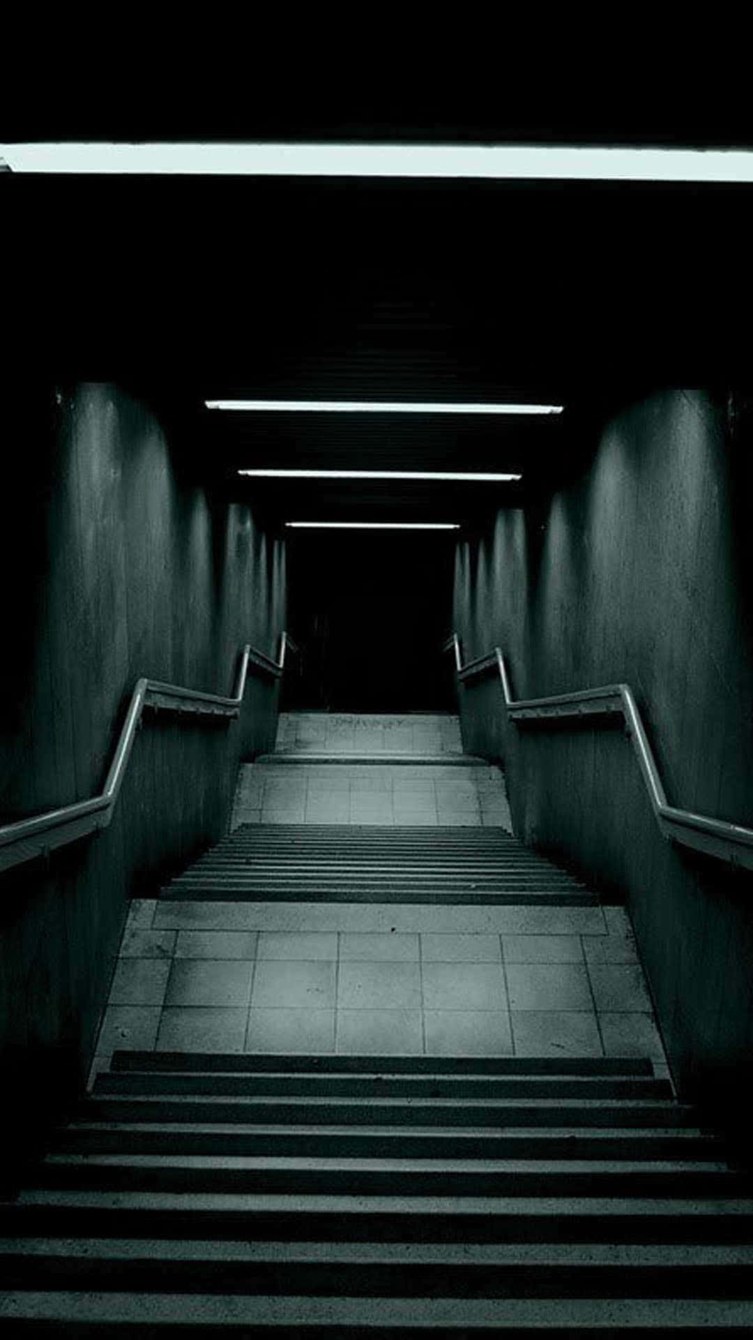 A Dark Hallway With Stairs And Lights