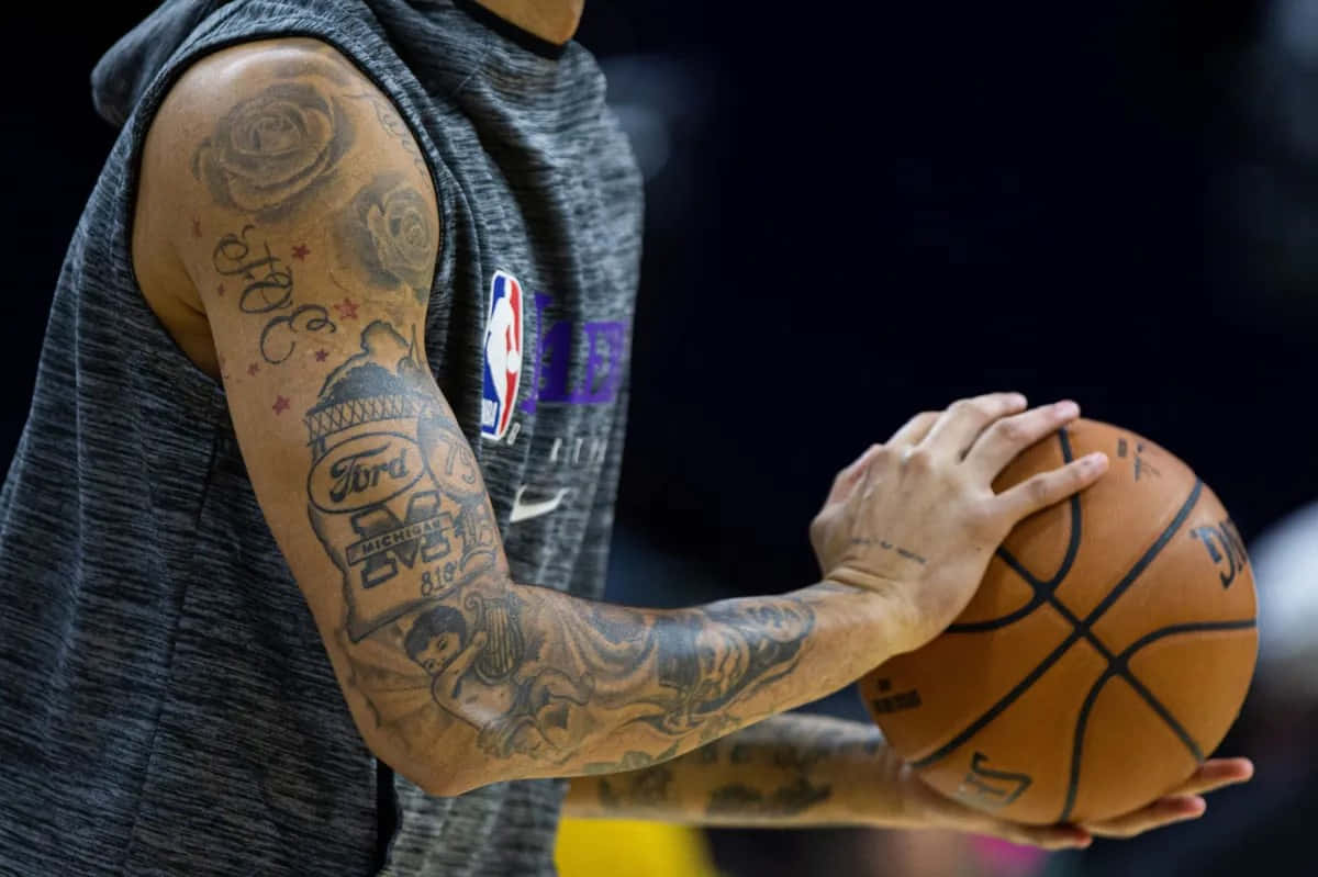 N B A Player Tattooed Arm Holding Basketball Wallpaper