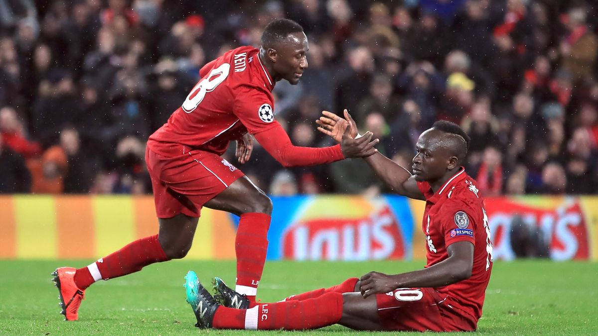 Nabykeita Hjälper Lagkamrat (as A Computer Or Mobile Wallpaper, You Can Add An Image Of Naby Keita Helping A Teammate On The Field To Go Along With The Text) Wallpaper