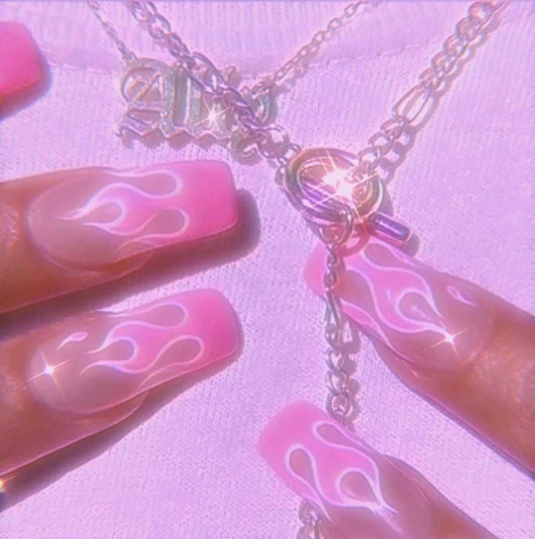 A Pink Nail With A Pink Flame Design