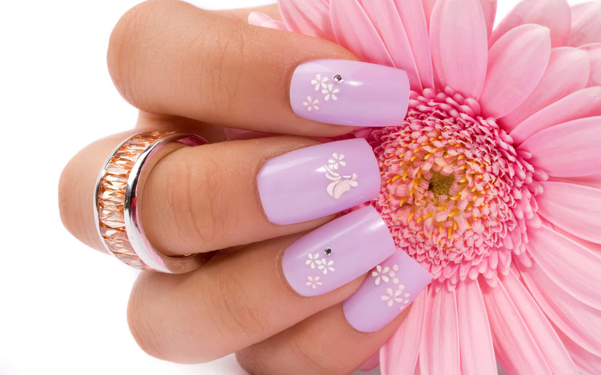 A Woman With Purple Nails And A Flower