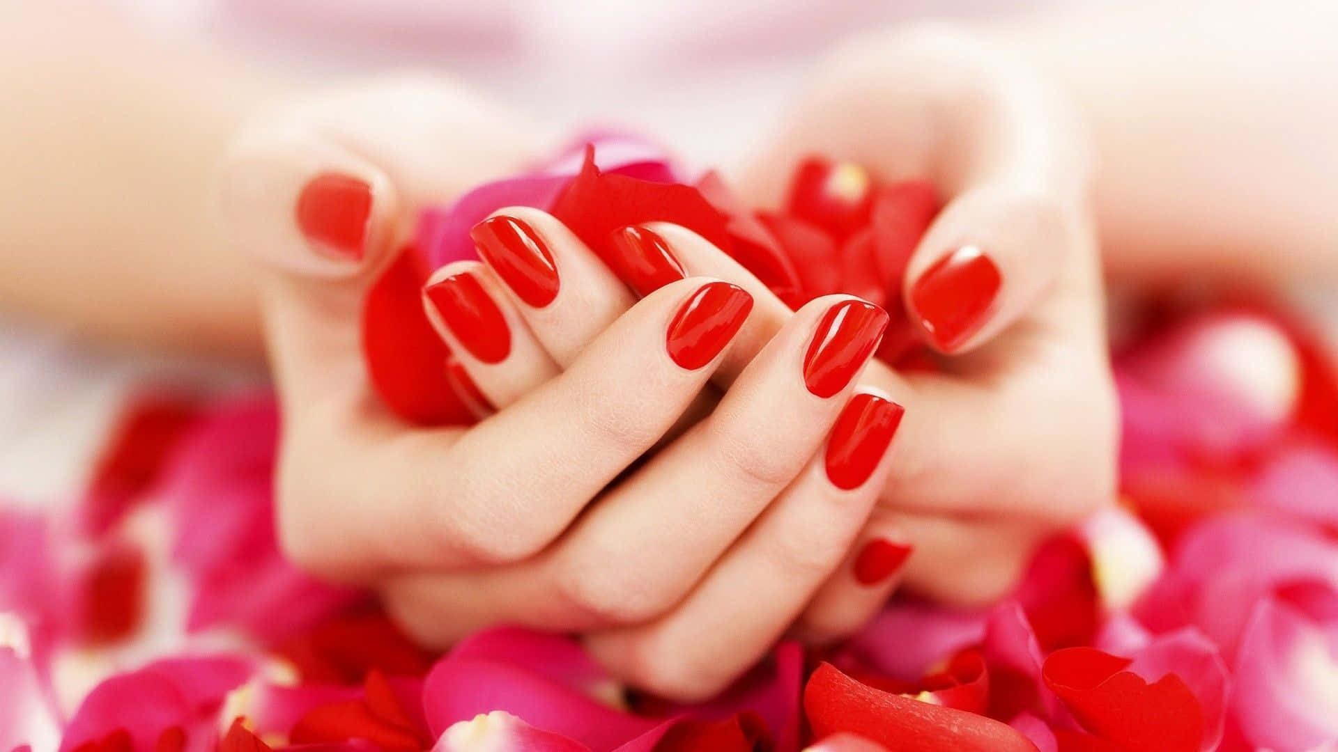 Girl's Hands With Red Nail Art And Petals Picture