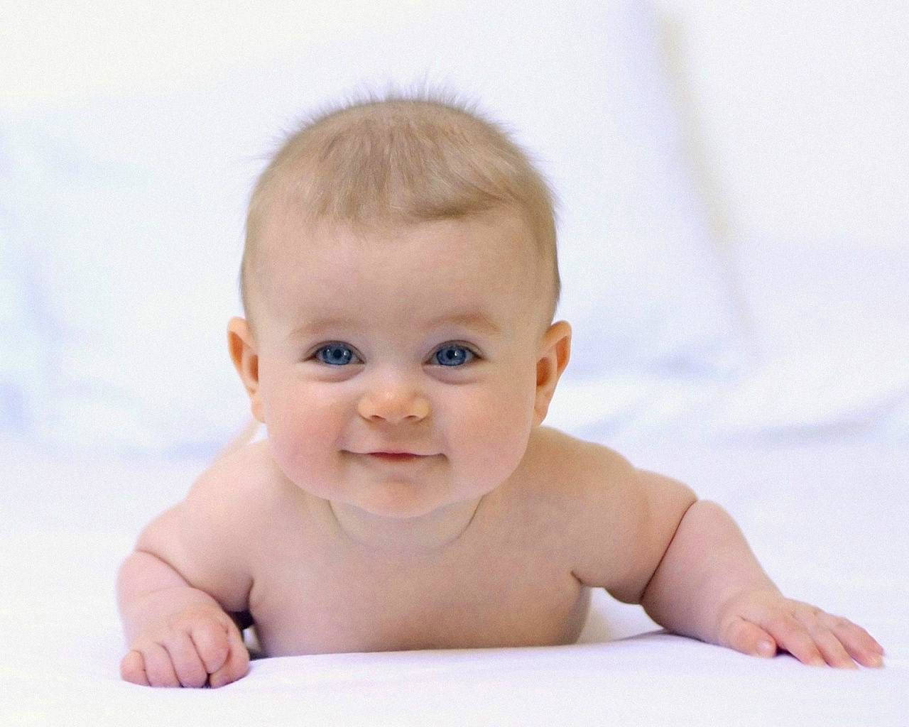 A Smiling Newborn Baby Wallpaper