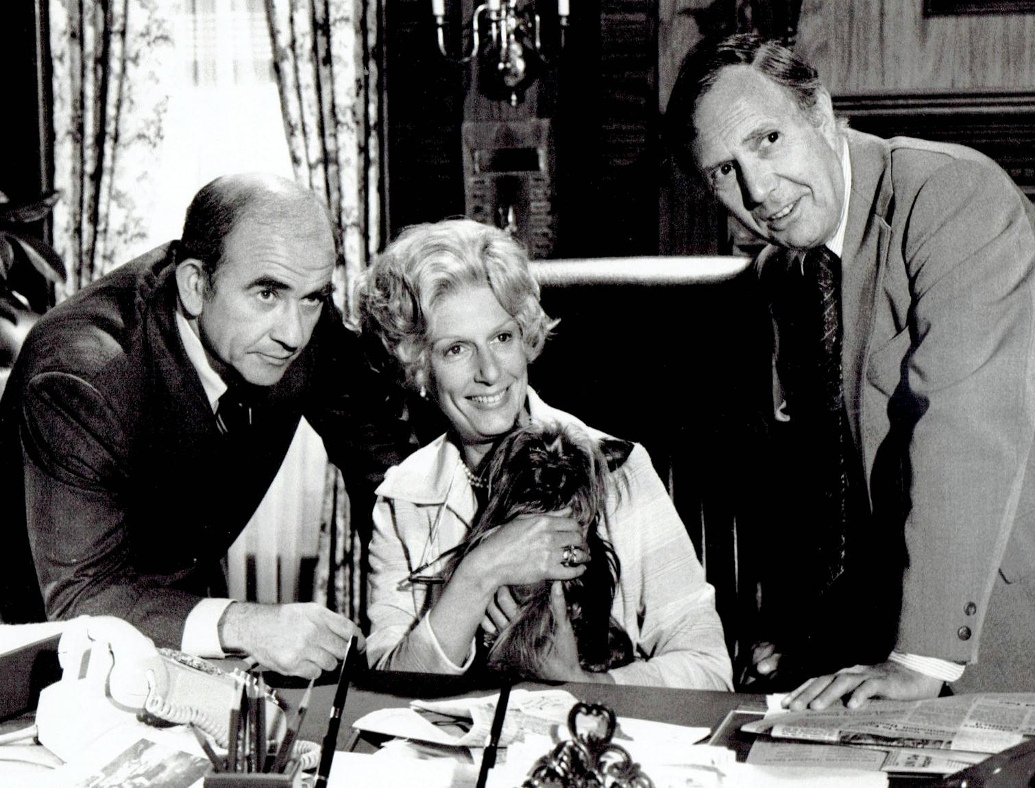 Nancy Marchand With Actors By Desk Wallpaper