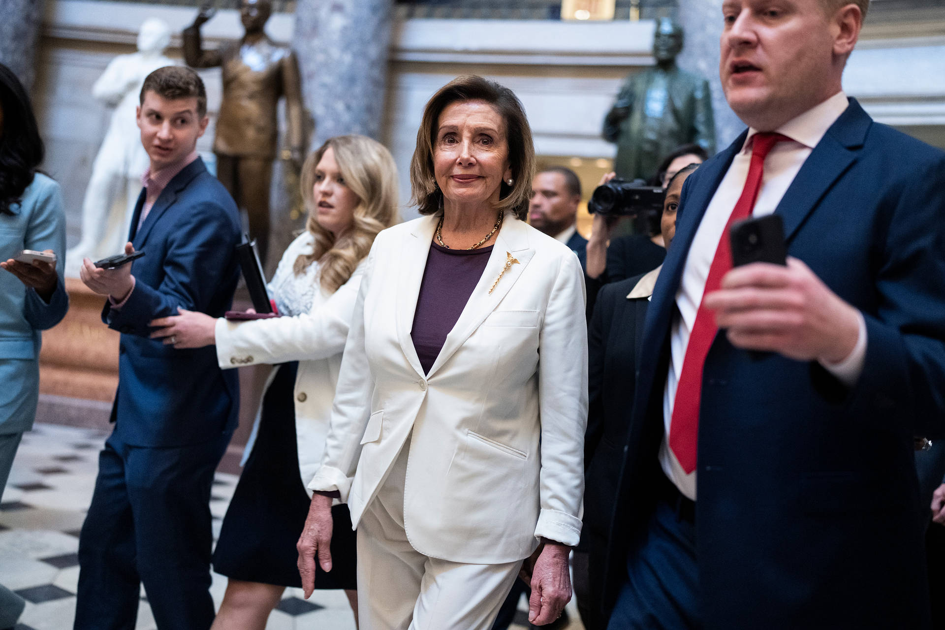 Nancy Pelosi Surrounded By Staff Wallpaper